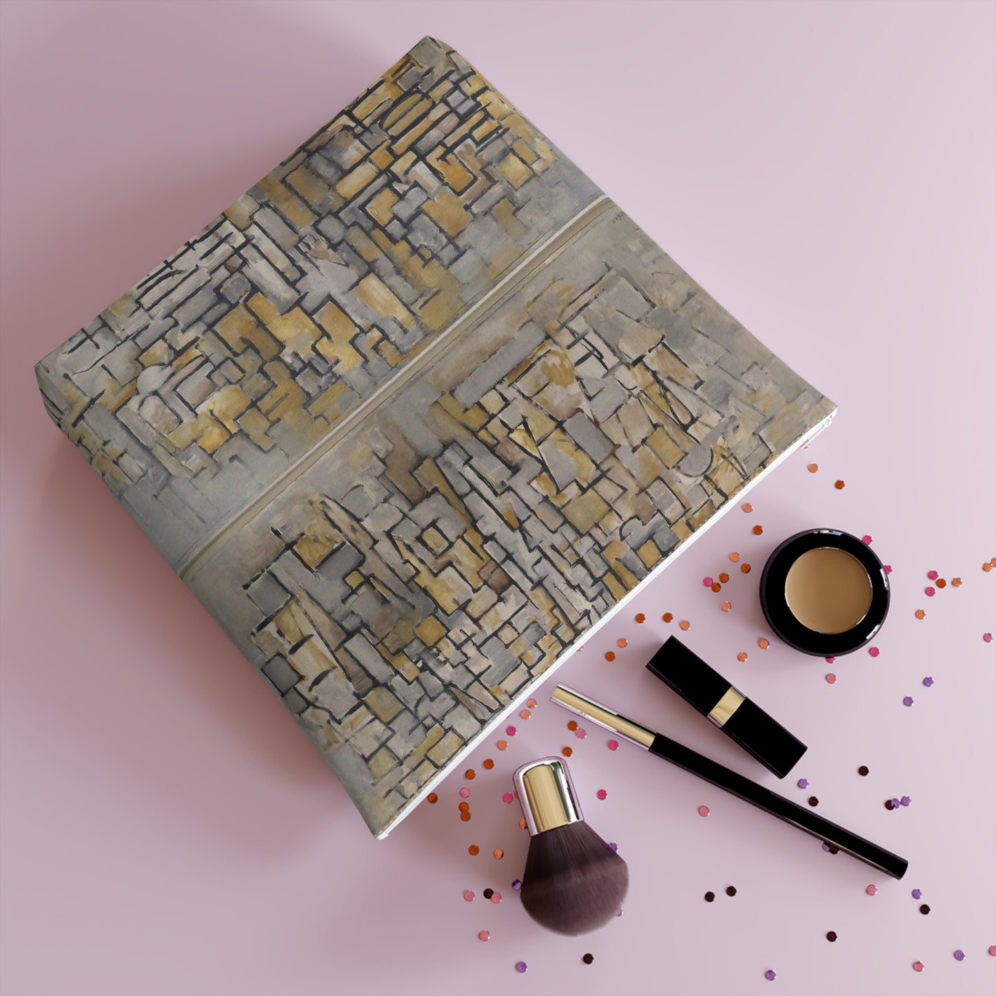 the contents of a makeup set on a pink background