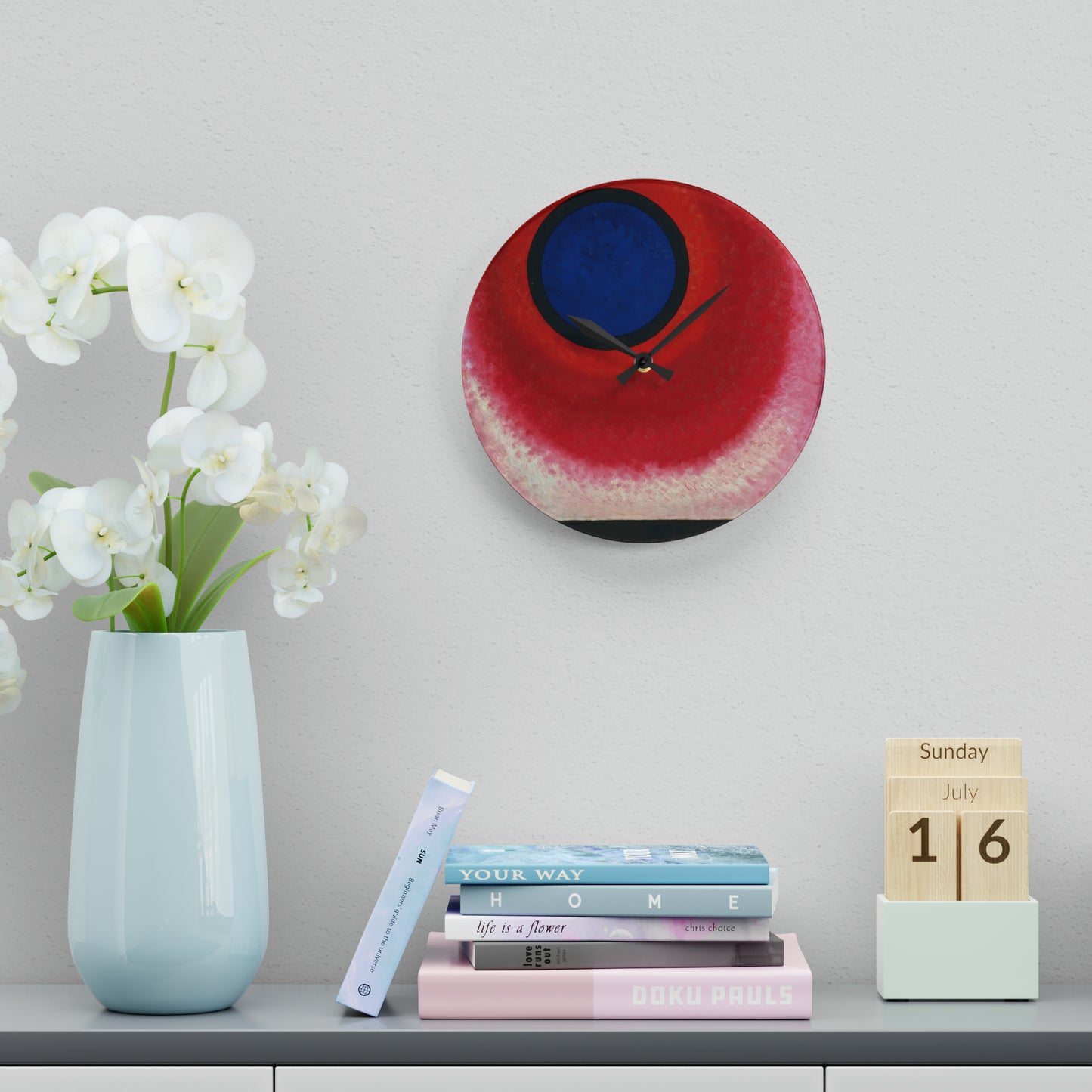 a clock on a wall next to a vase with flowers