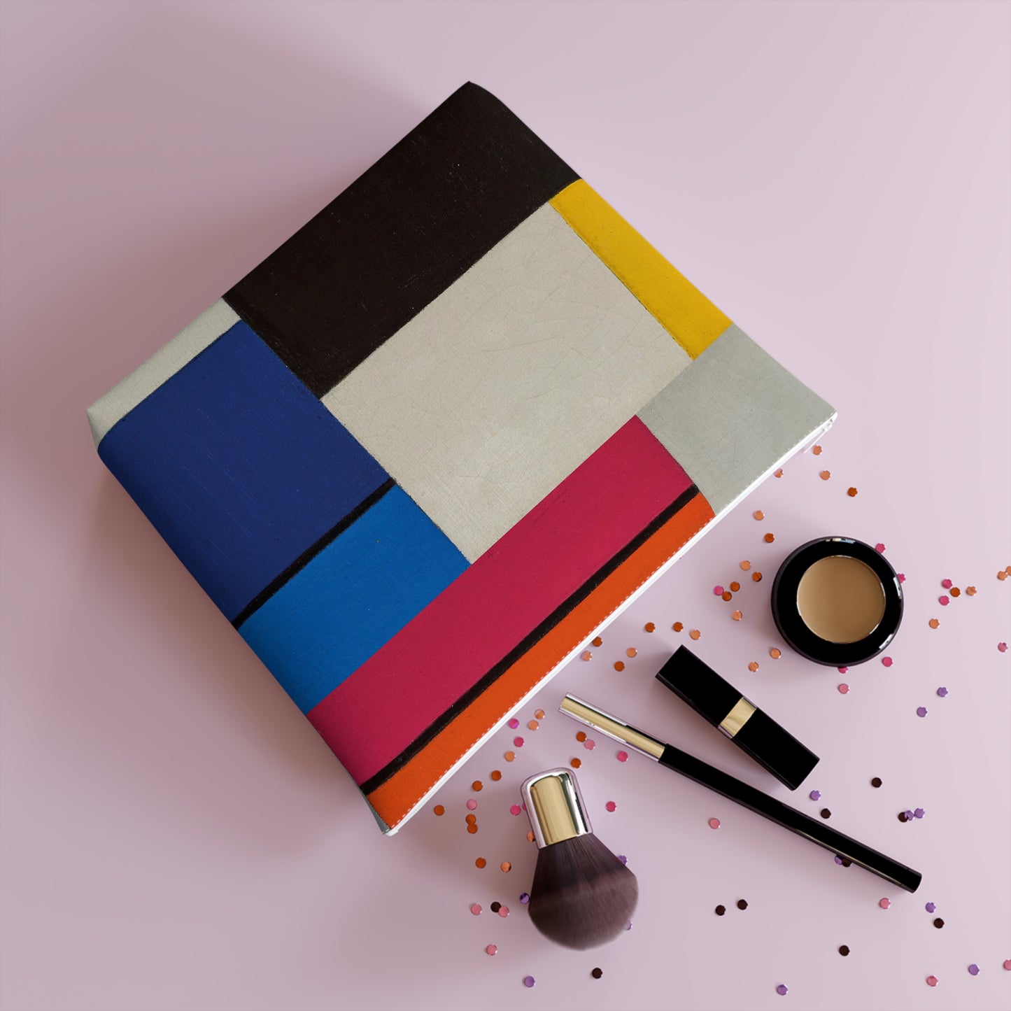 a table topped with makeup and confetti