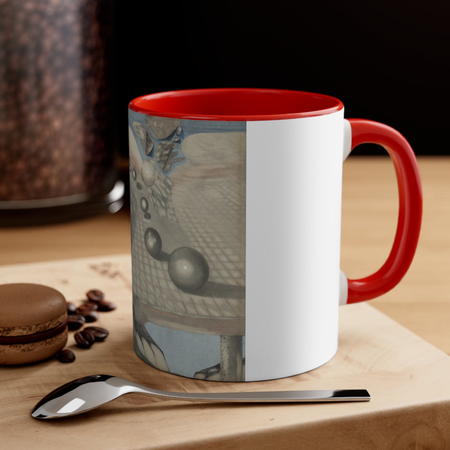 a red and white coffee mug sitting on top of a wooden table