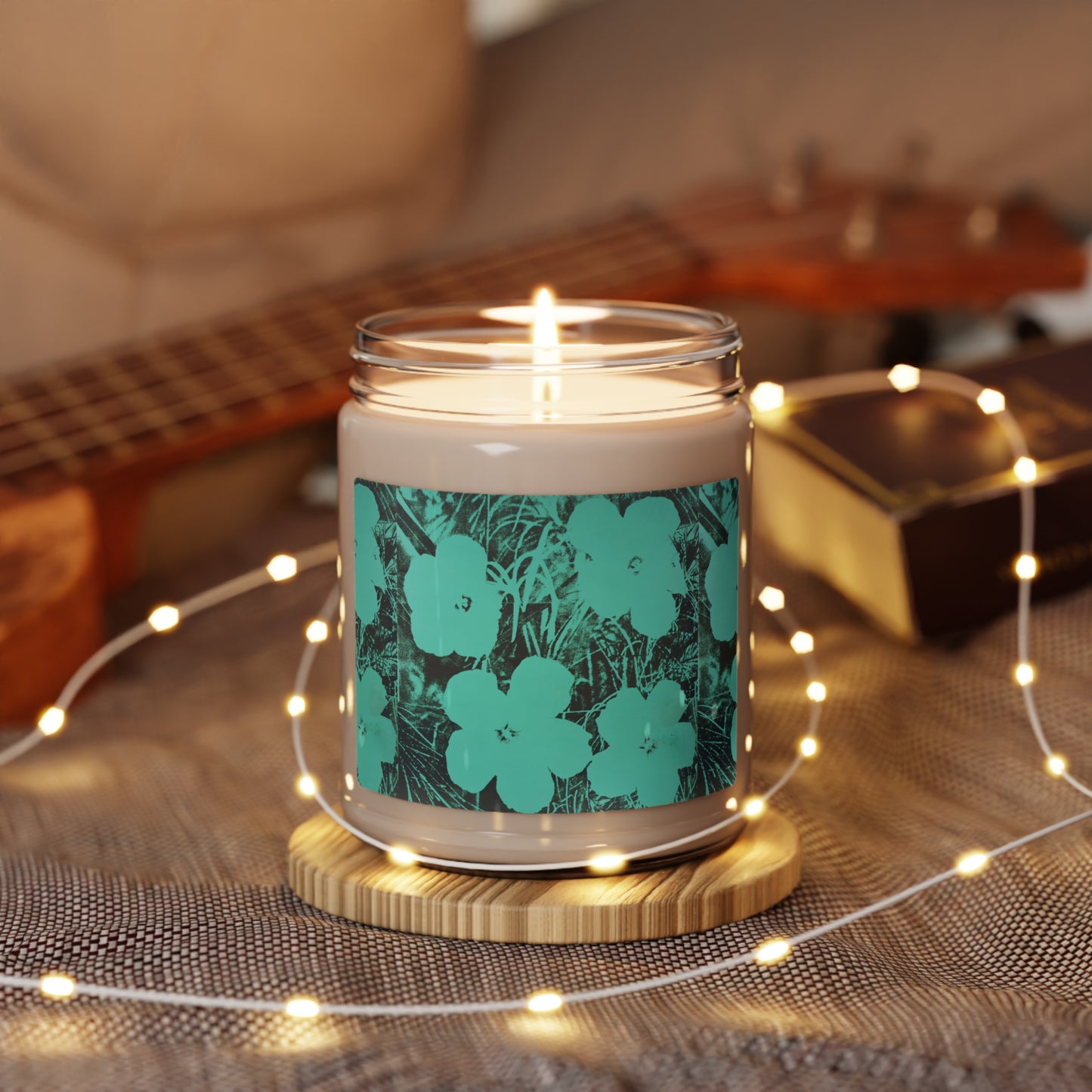 a candle sitting on top of a table next to a guitar