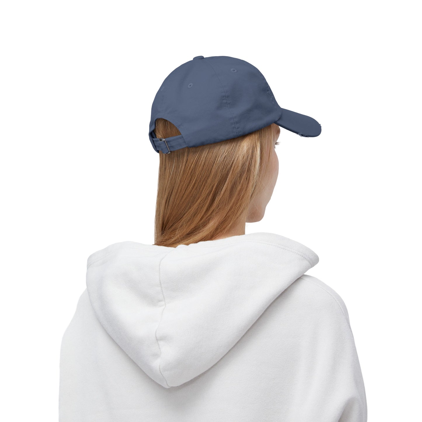 a woman wearing a white hoodie and a blue cap