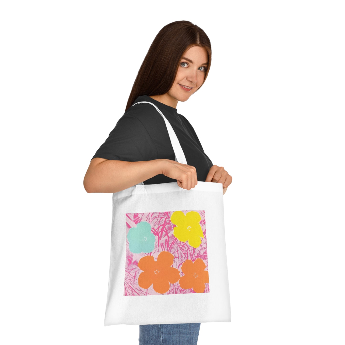 a woman holding a white bag with flowers on it