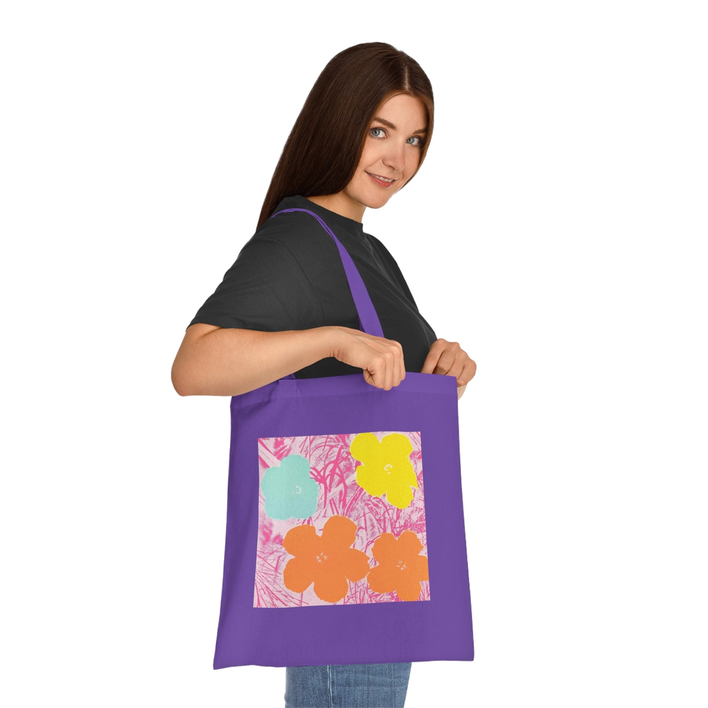 a woman holding a purple bag with flowers on it