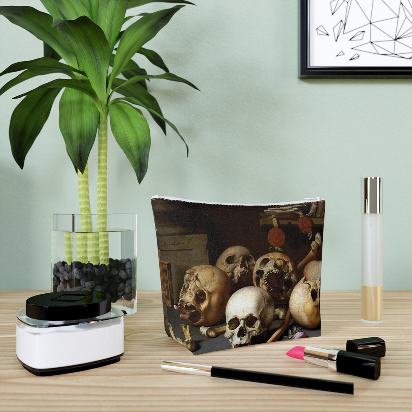 a desk with a plant and a picture of skulls