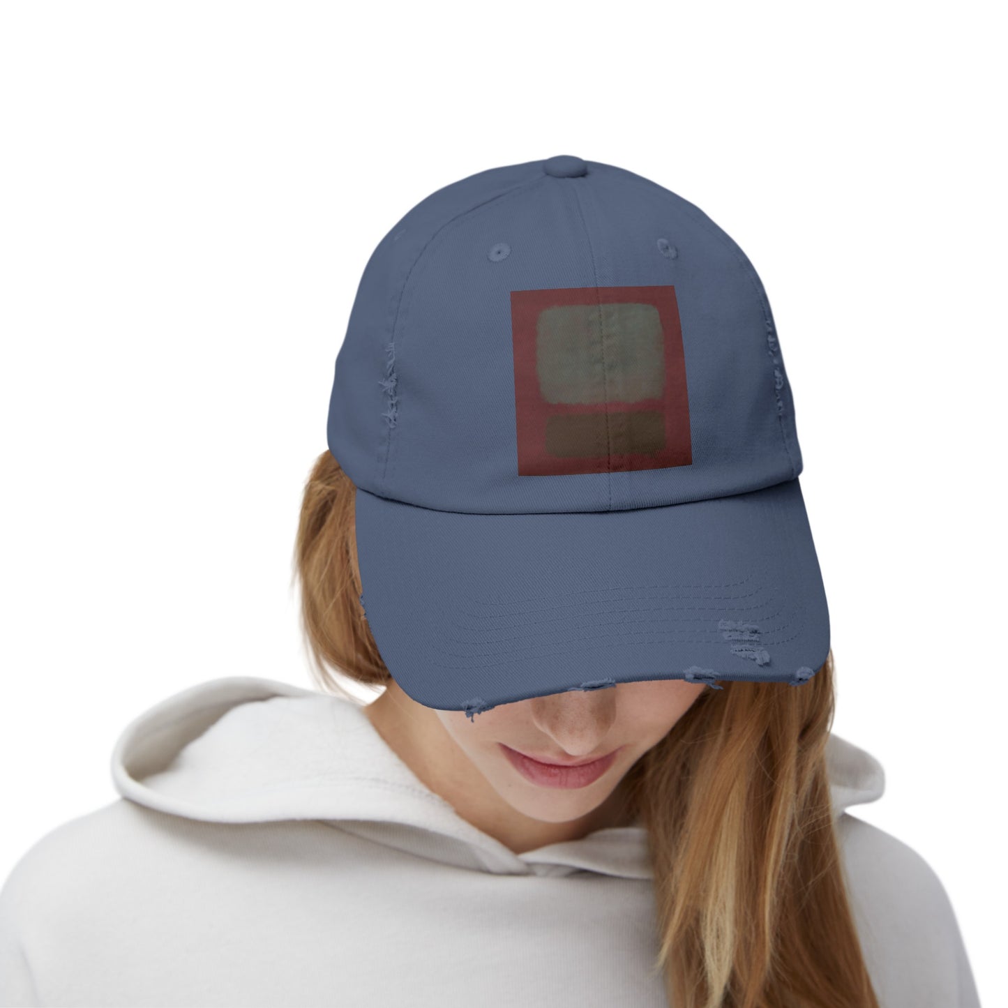 a woman wearing a blue hat with a red square on it