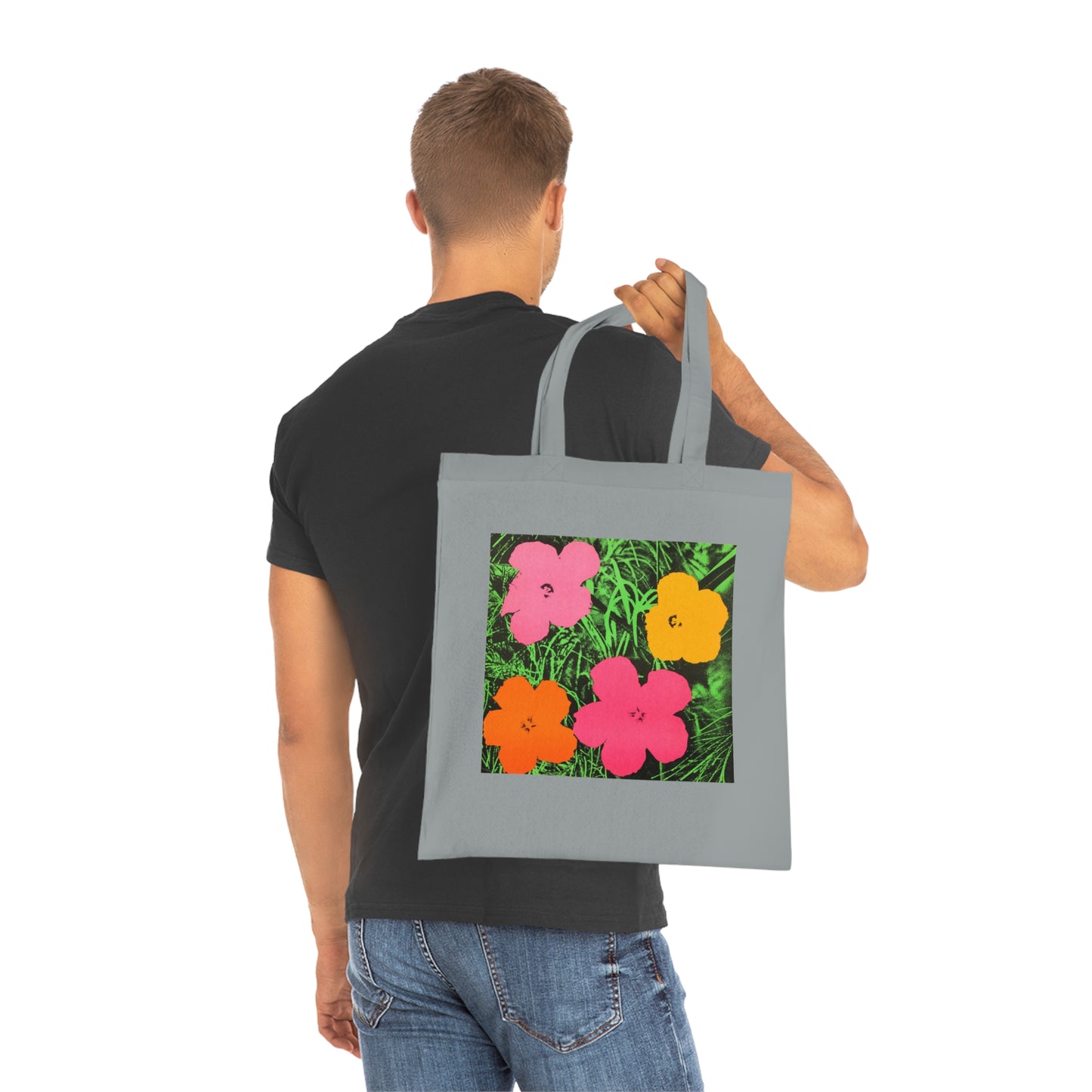 a man carrying a tote bag with flowers on it