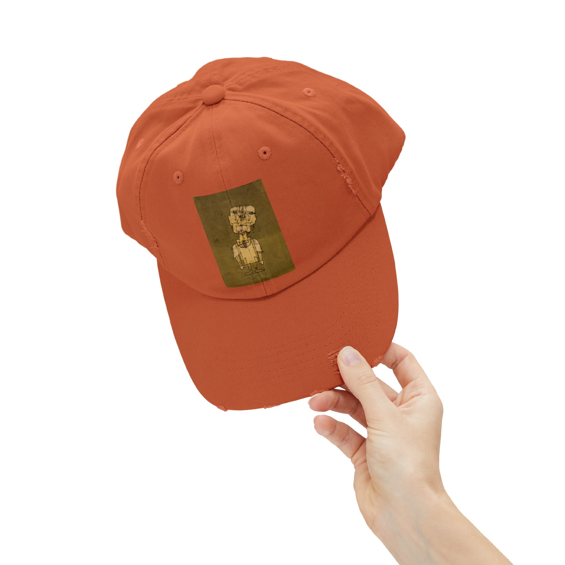a person holding a baseball cap with a bear on it