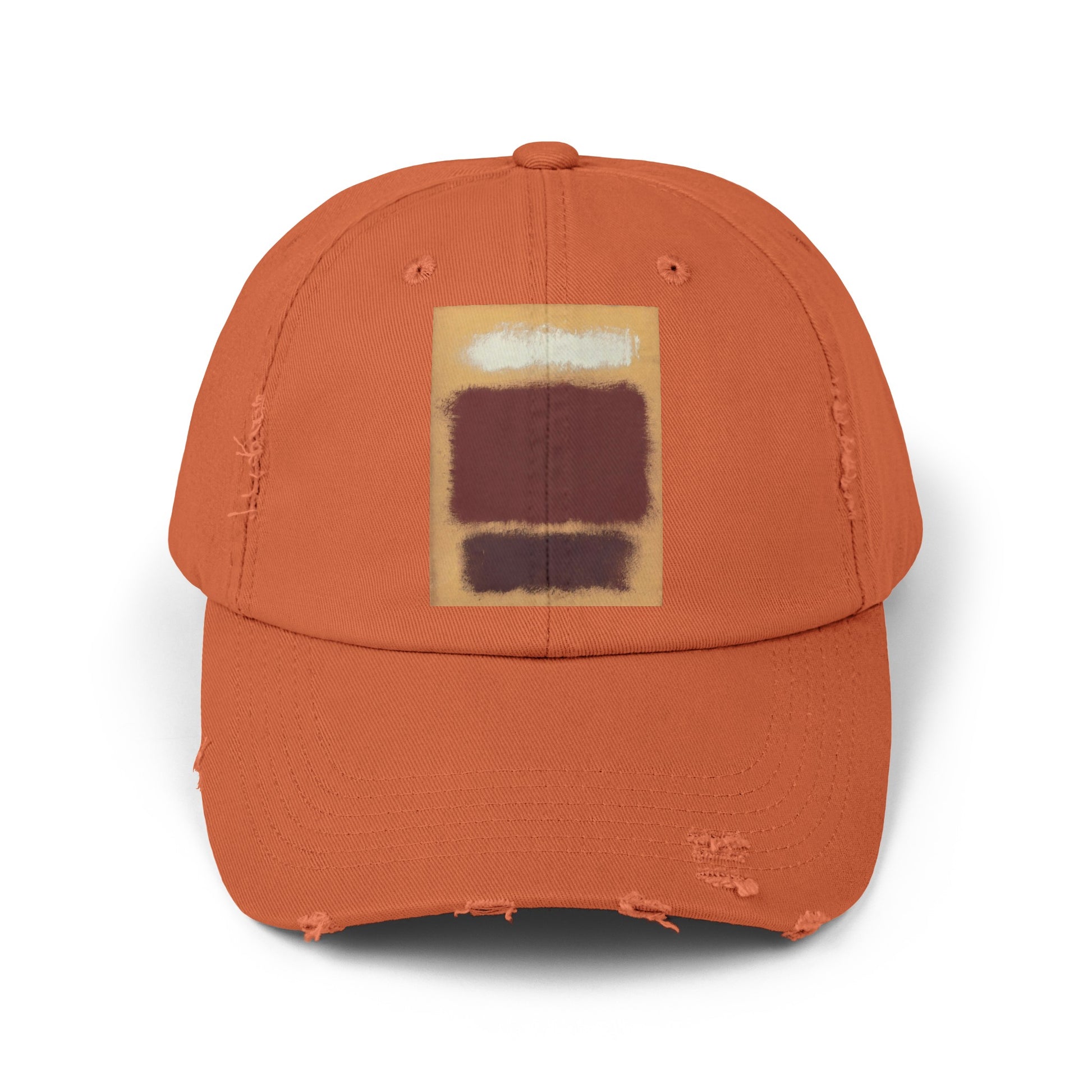 an orange hat with a brown and white square on it