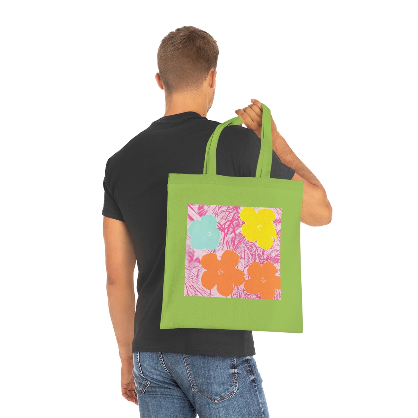 a man holding a green shopping bag with flowers on it