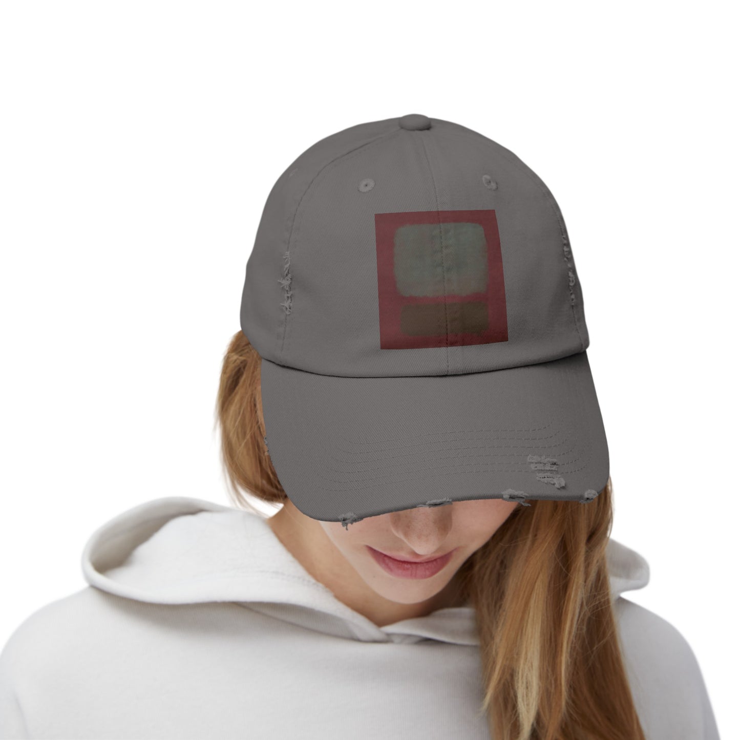 a woman wearing a gray hat with a red square on it
