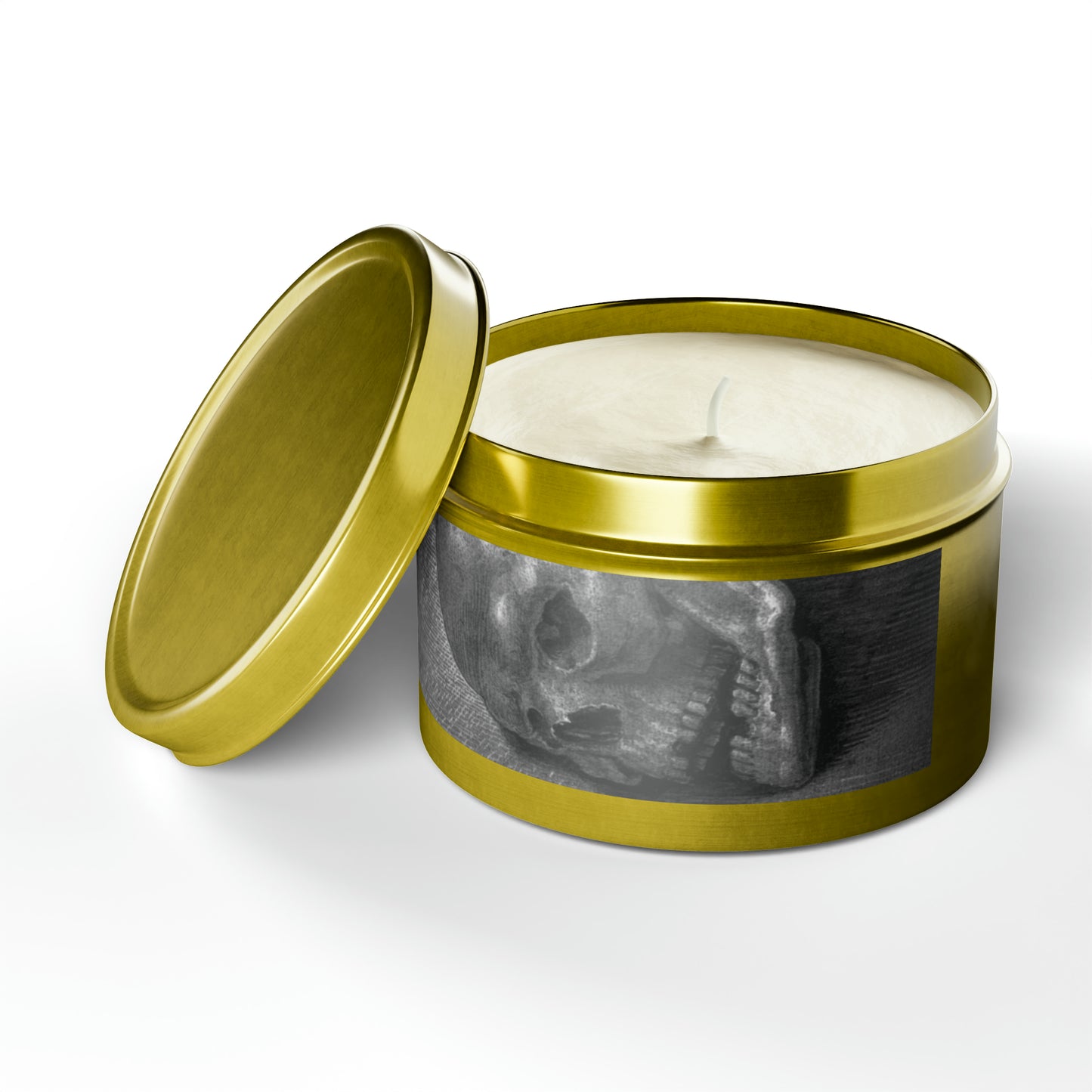 a candle in a tin with a gold lid