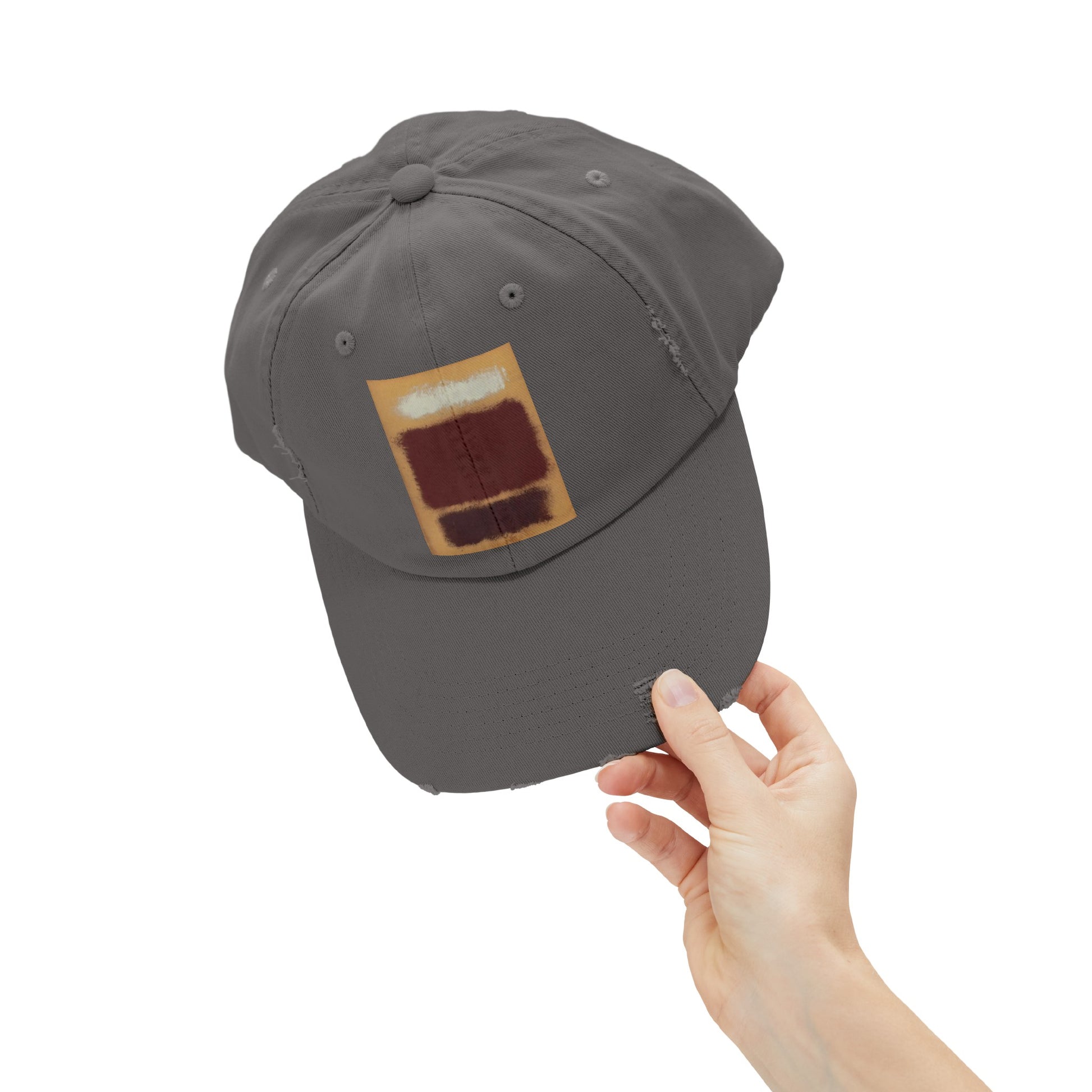 a person holding a gray hat with a patch on it