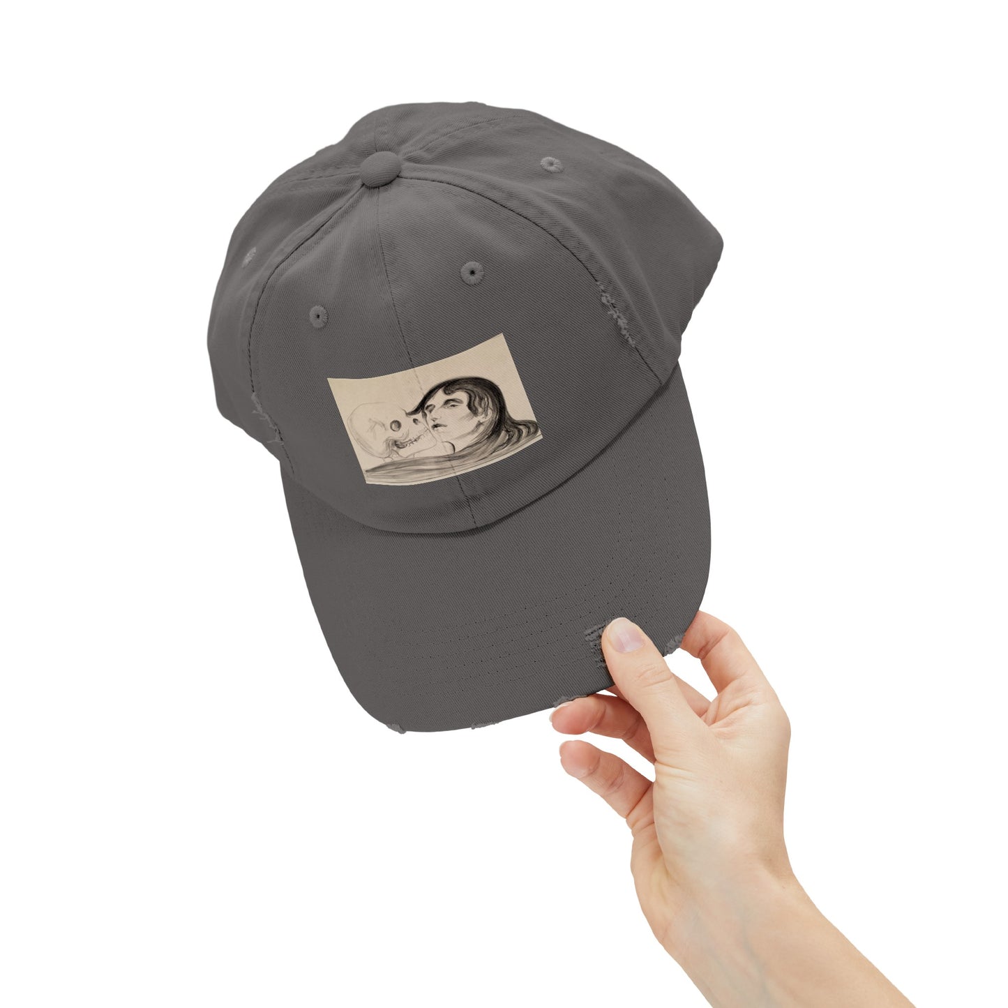 a person holding up a gray hat with a picture of a man on it