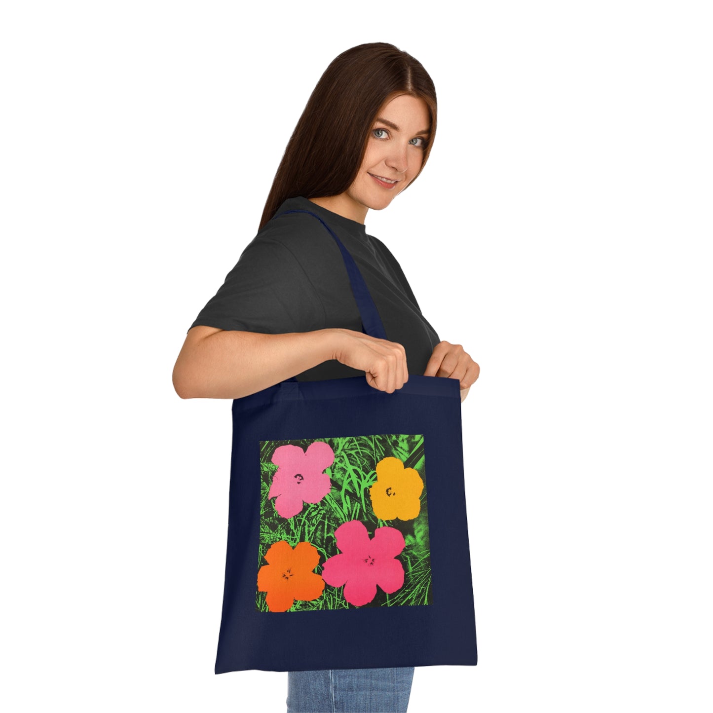 a woman holding a tote bag with flowers on it