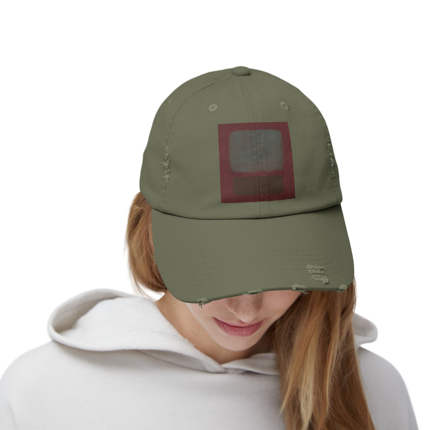 a woman wearing a green hat with a red square on it