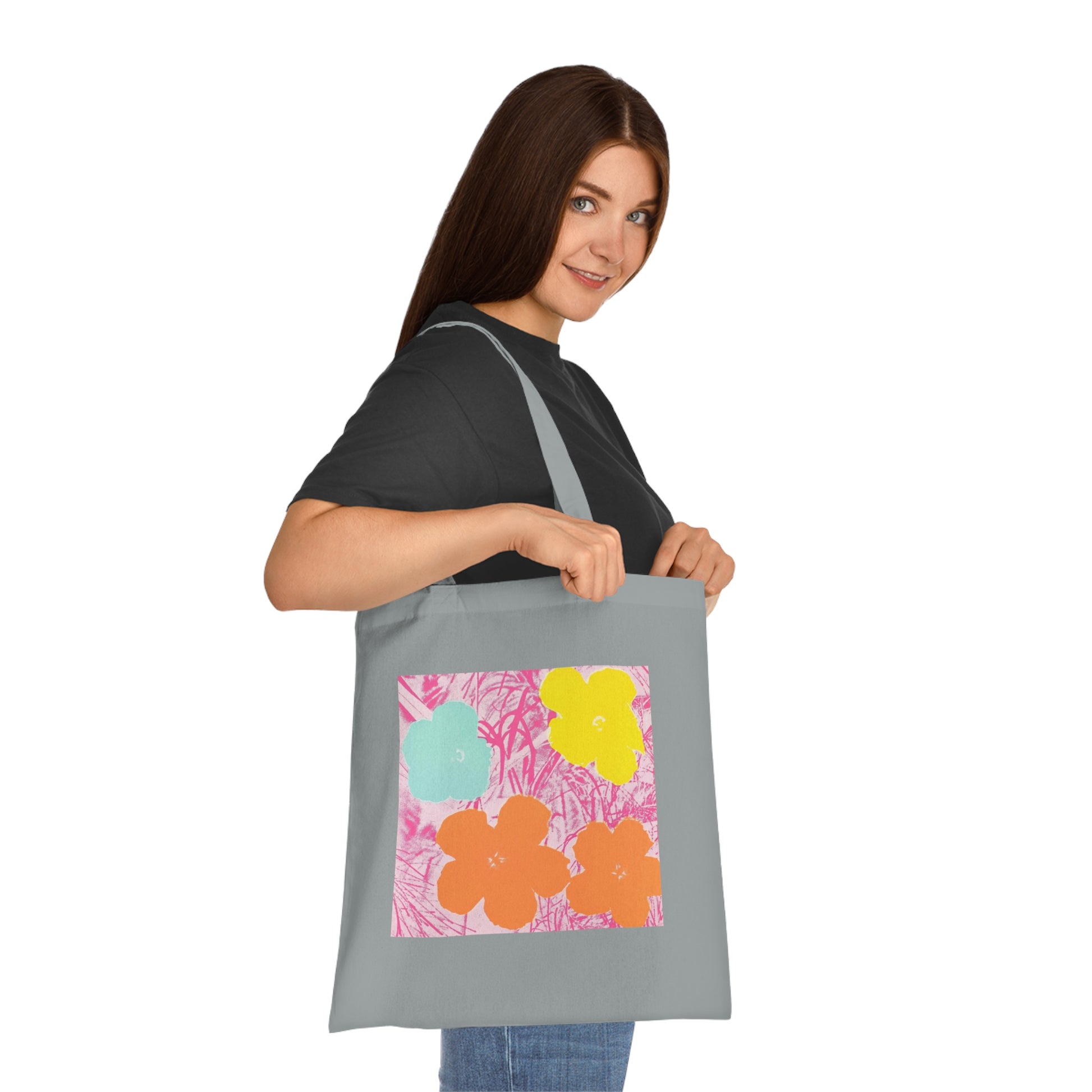 a woman is holding a large bag with flowers on it