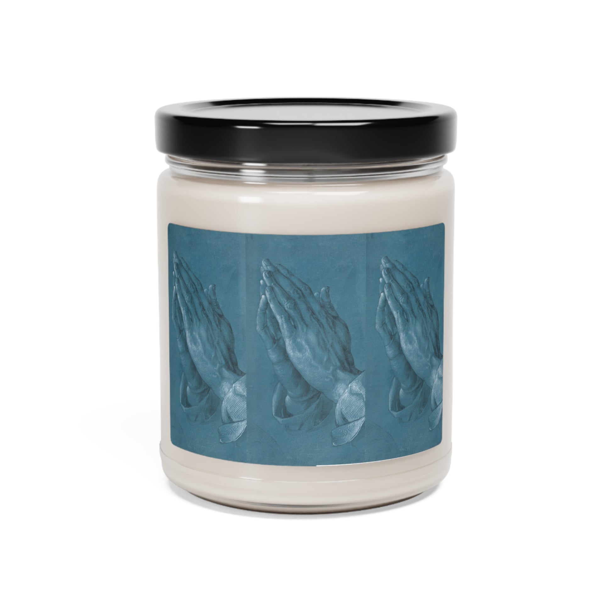a candle with a picture of hands on it