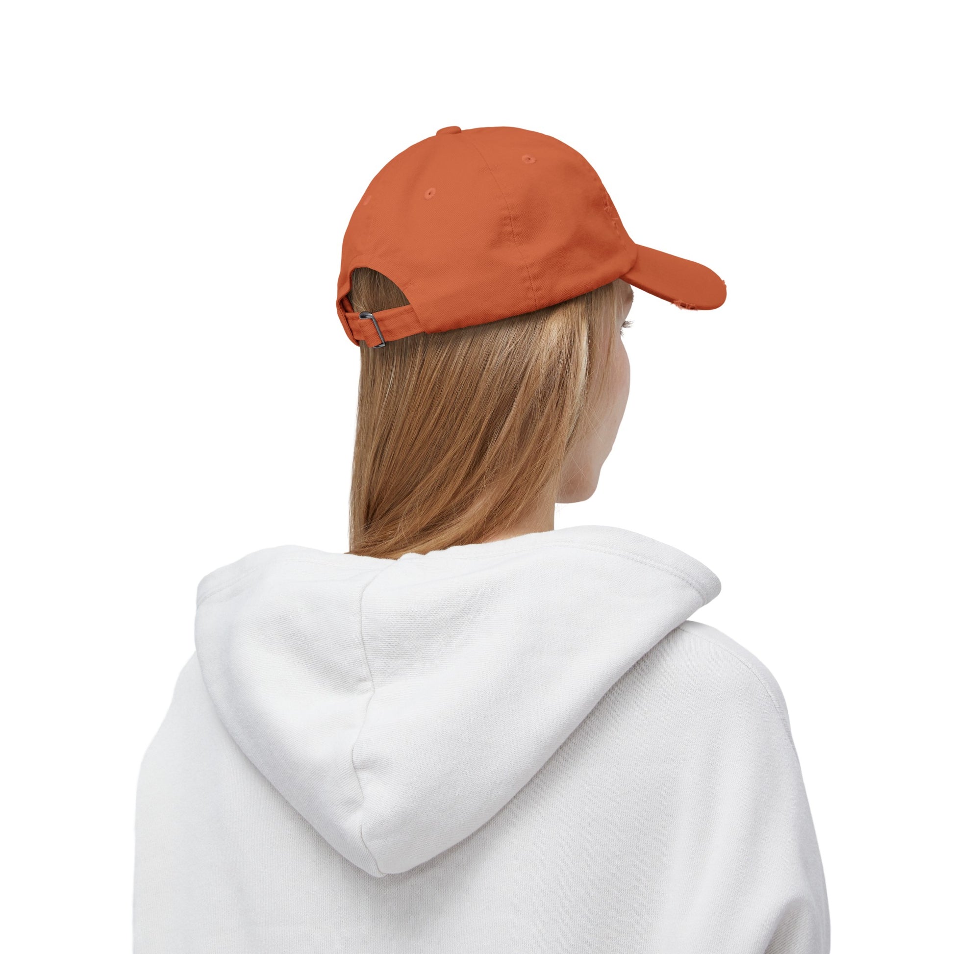 a woman wearing an orange hat and a white sweatshirt