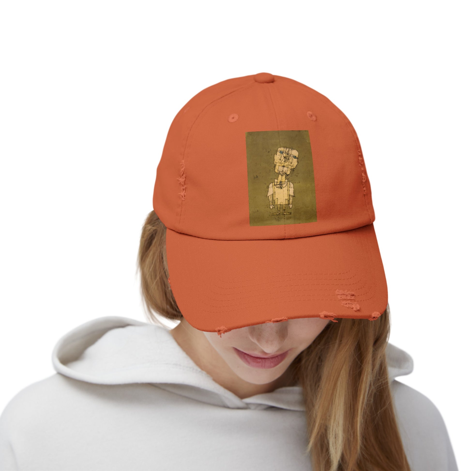 a woman wearing an orange hat with a picture of a dog on it