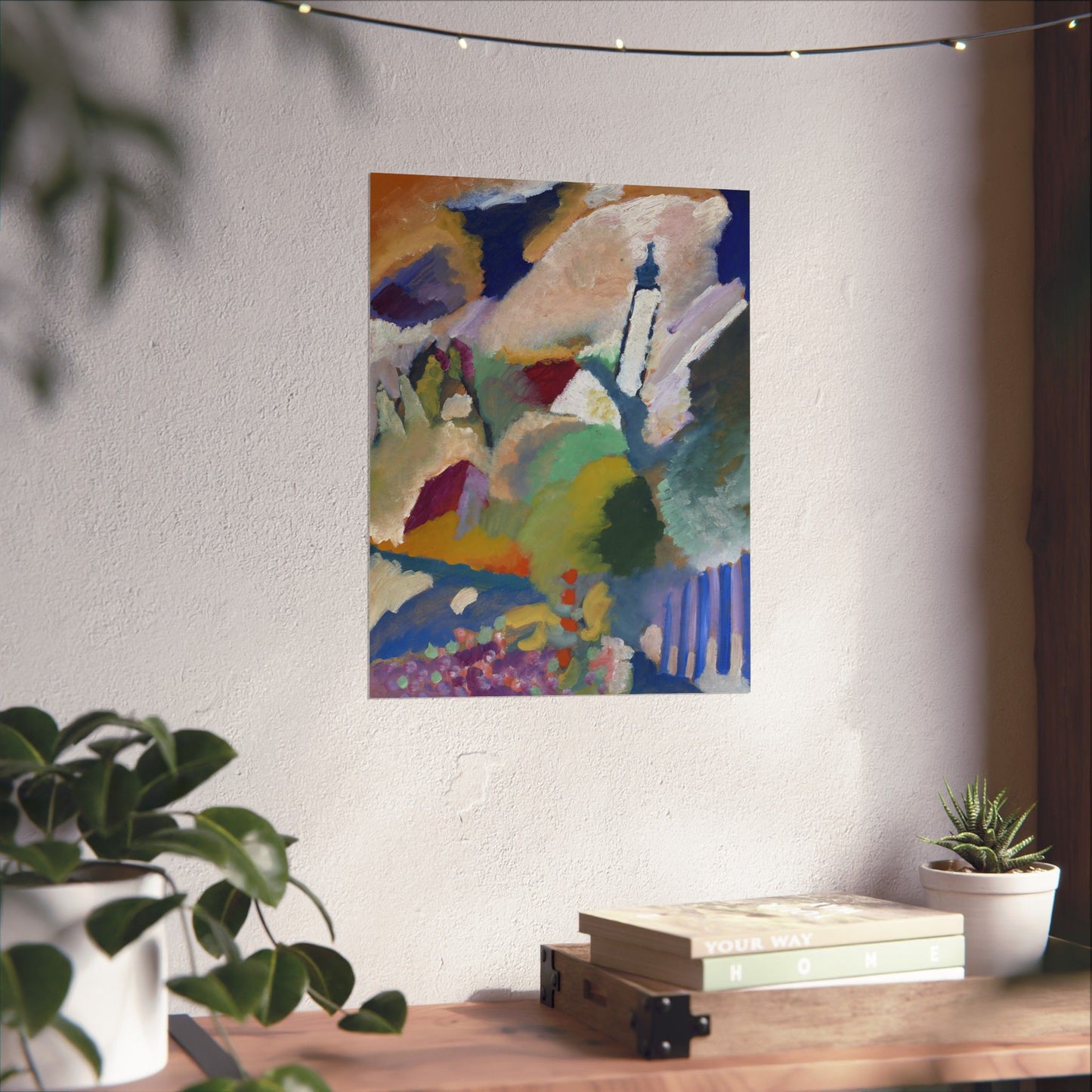 a painting hanging on a wall next to a potted plant