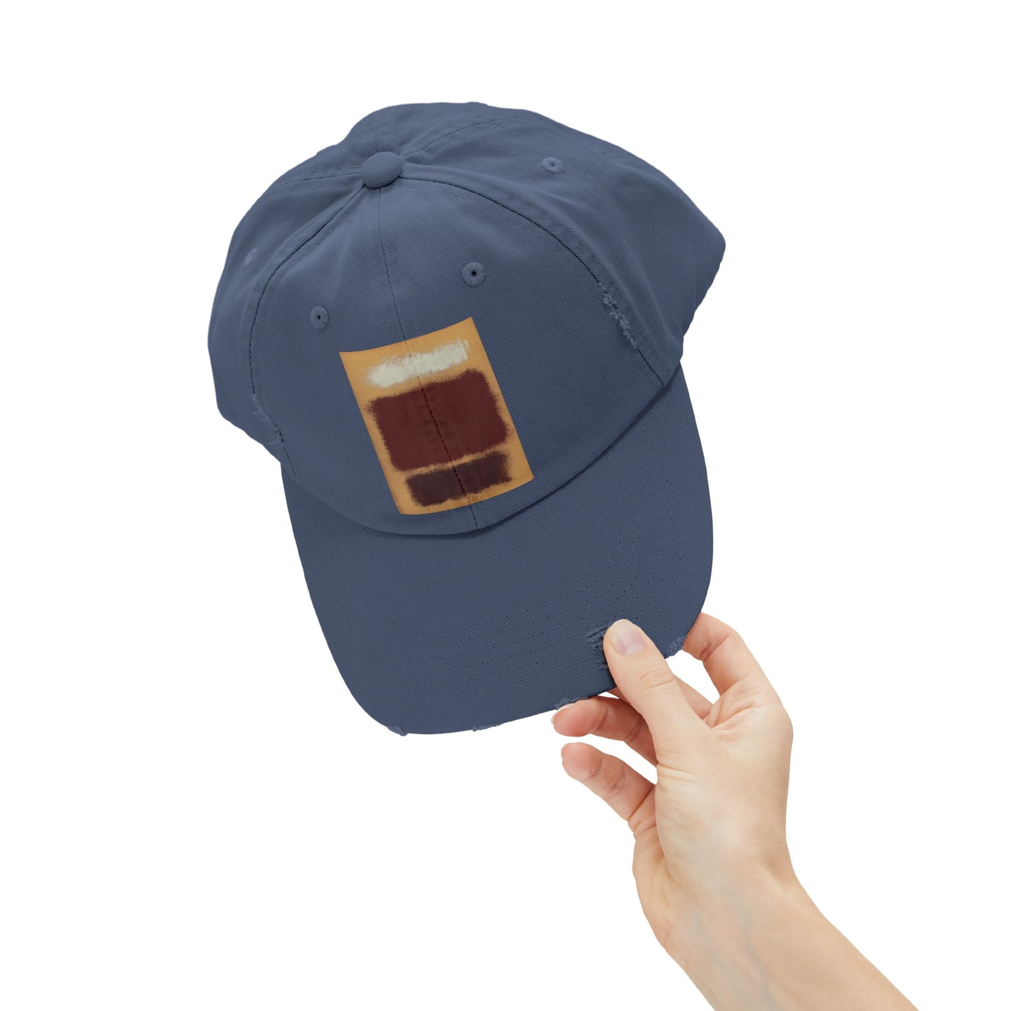 a person holding a hat with a patch on it