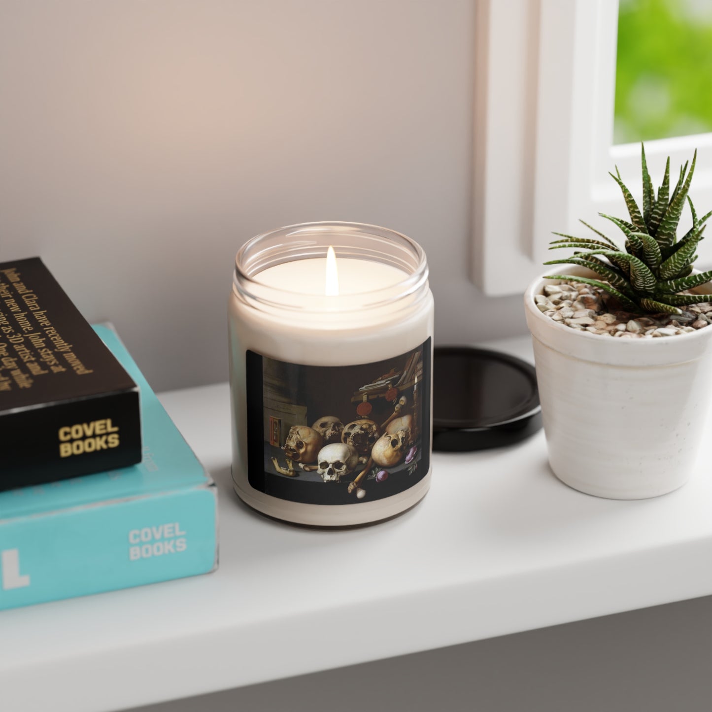 a candle sitting on top of a table next to a book