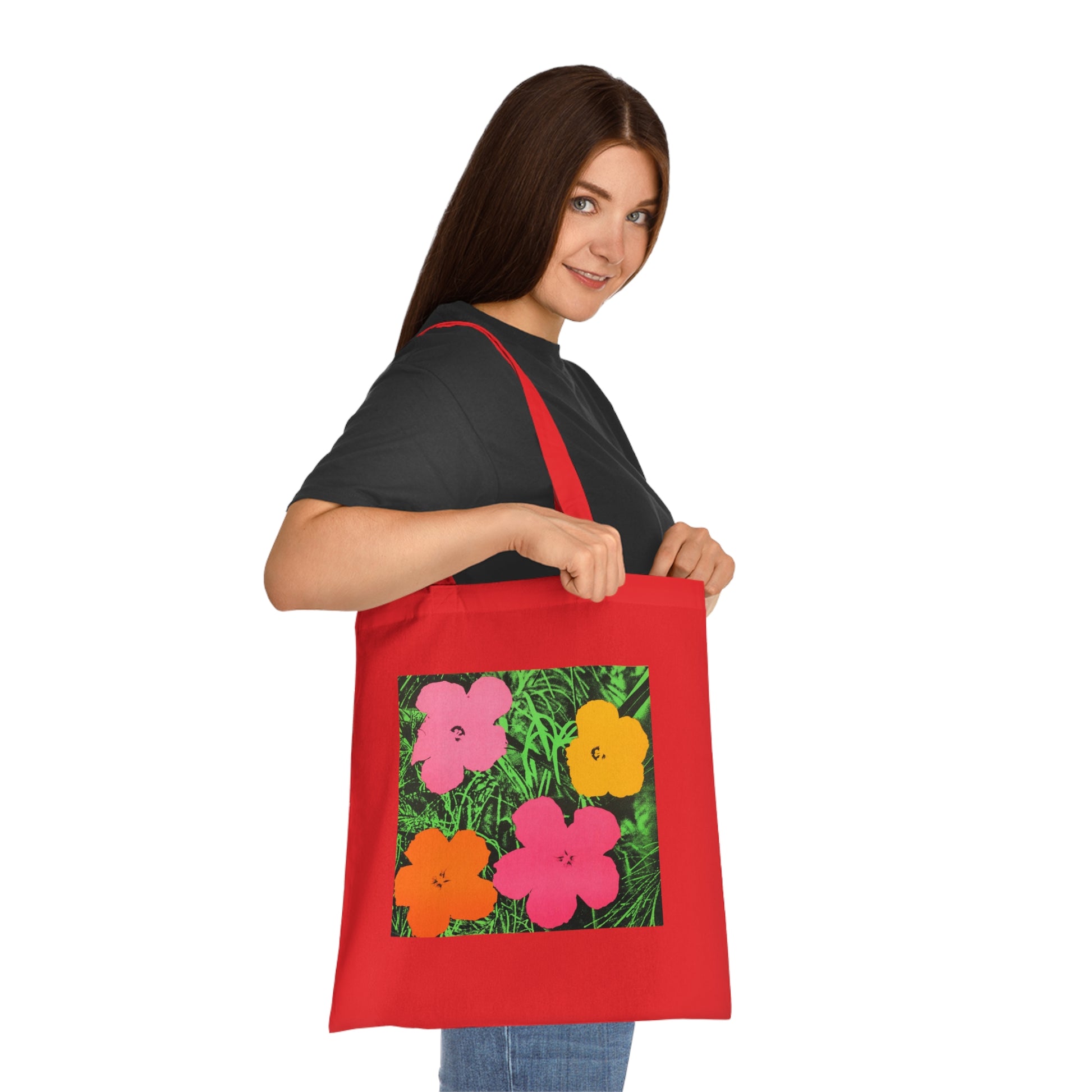 a woman holding a red bag with flowers on it