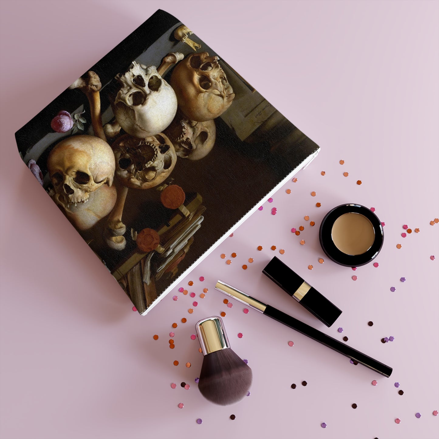 a table topped with makeup and a picture of skulls