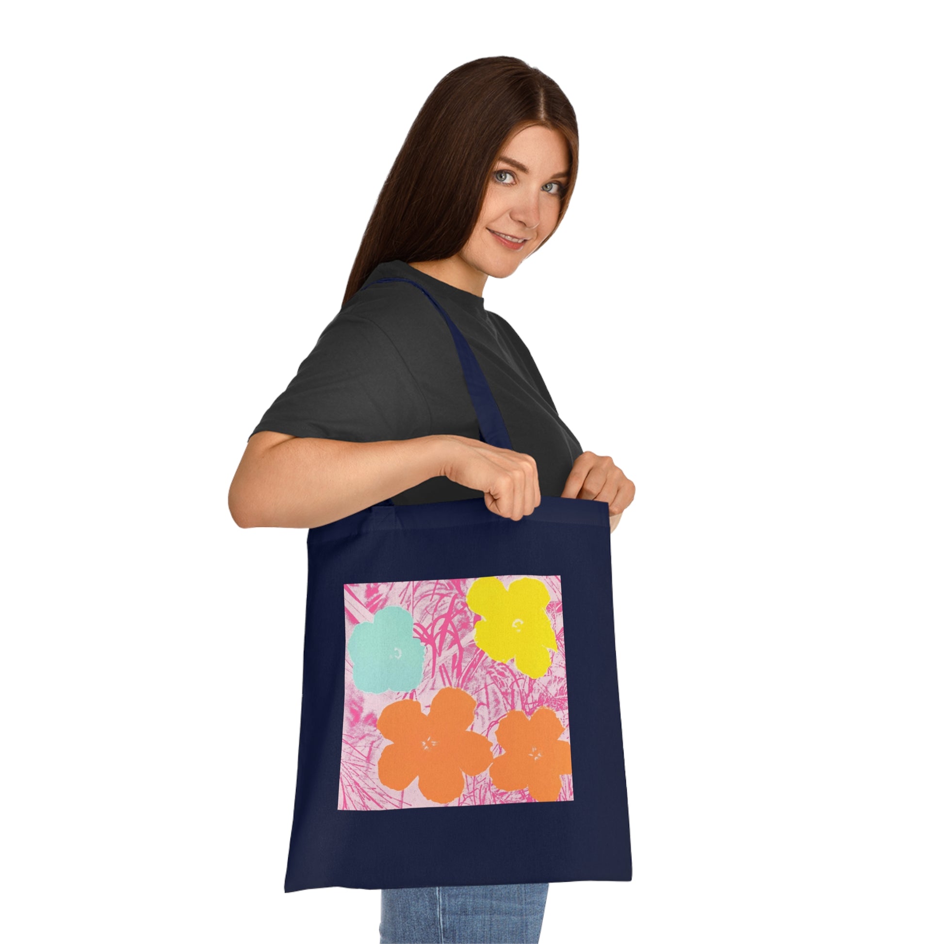 a woman holding a blue bag with flowers on it