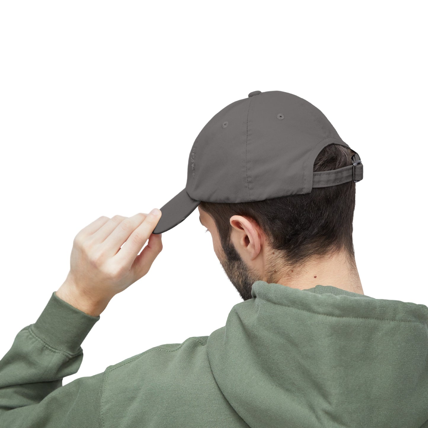 a man in a green hoodie putting a hat on his head