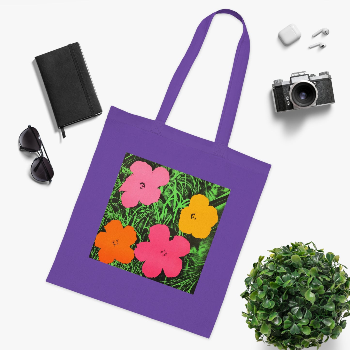 a purple tote bag with a picture of flowers on it