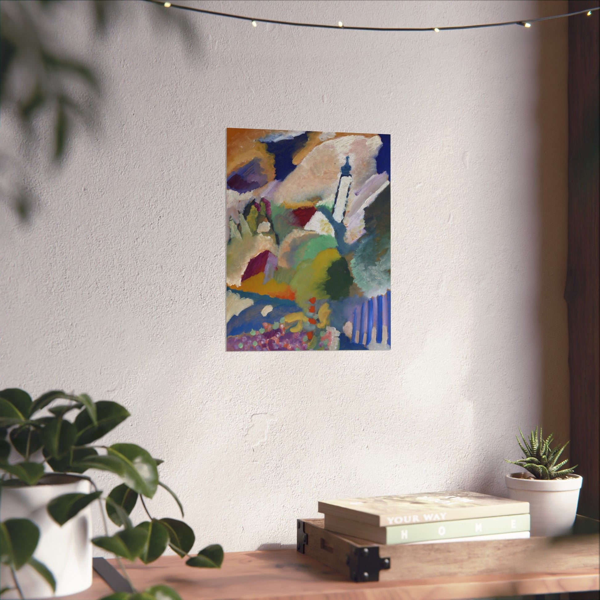 a painting hanging on a wall next to a potted plant