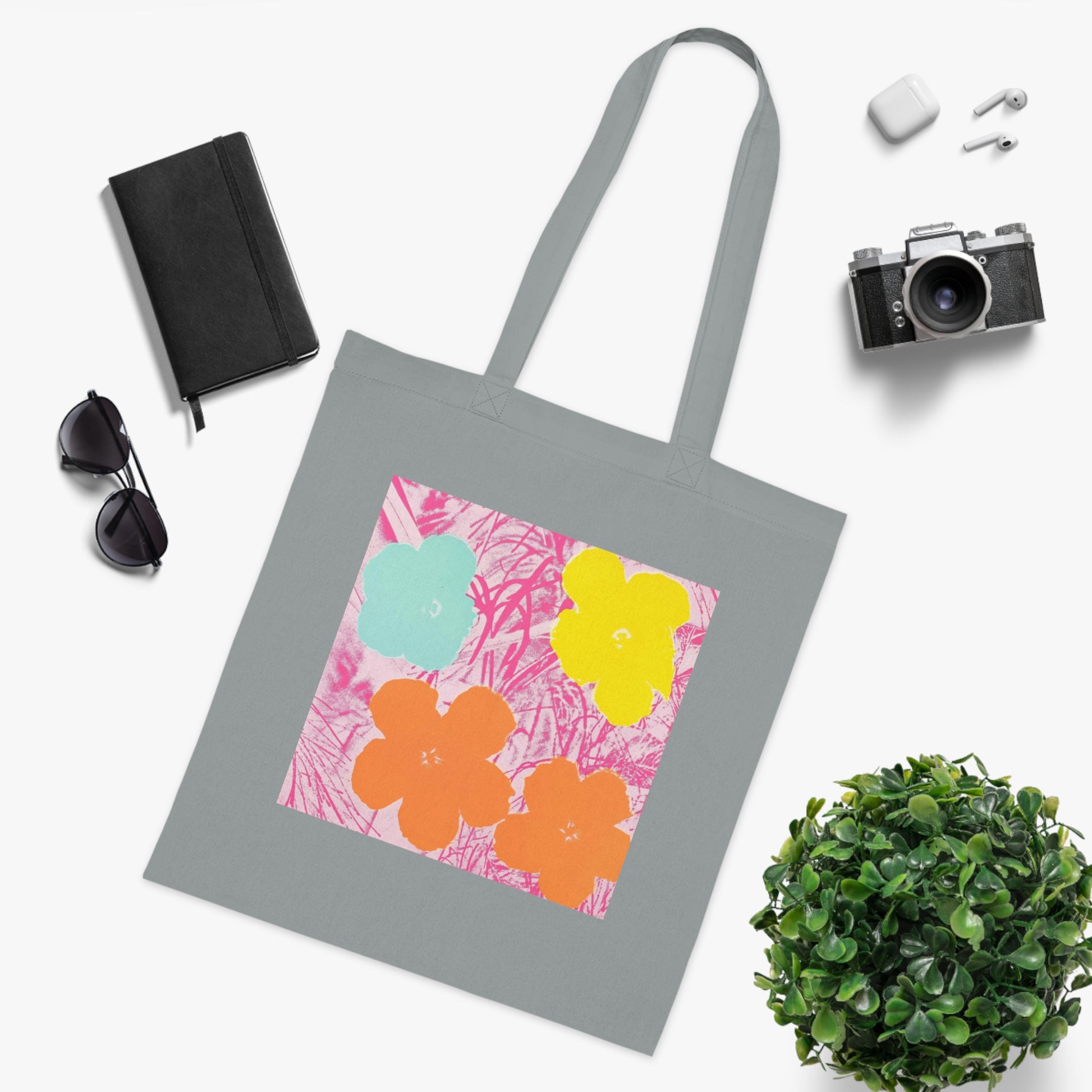 a tote bag sitting next to a potted plant