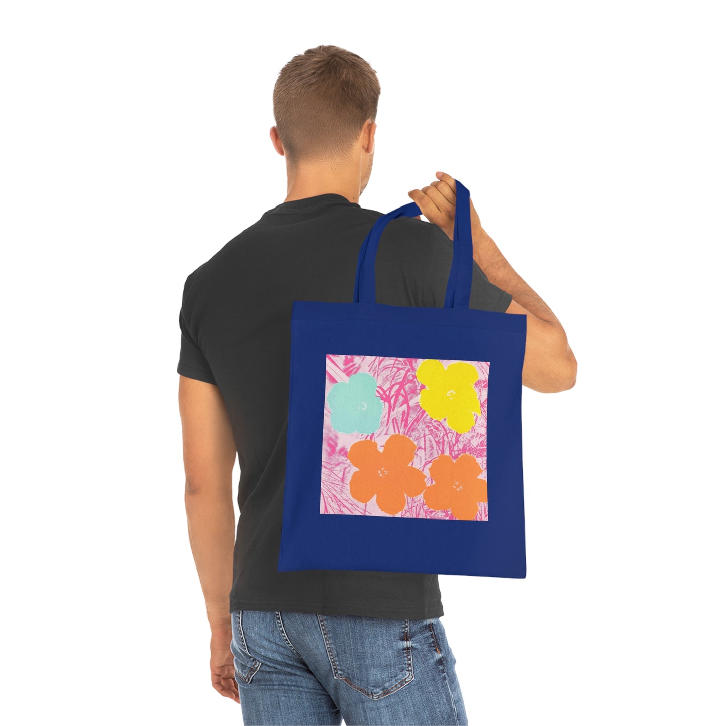 a man holding a blue bag with a painting on it