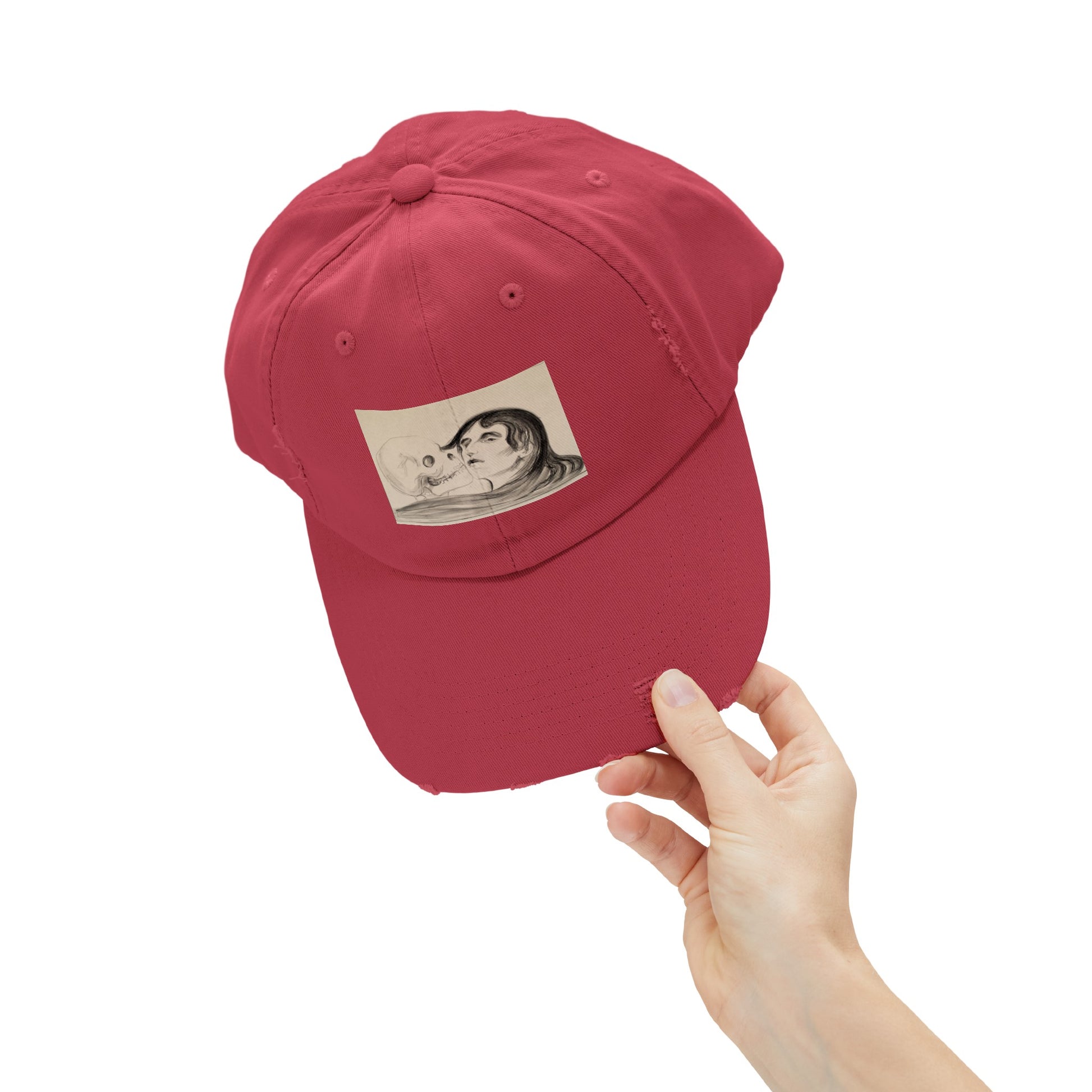 a person holding a red hat with a picture of a man on it