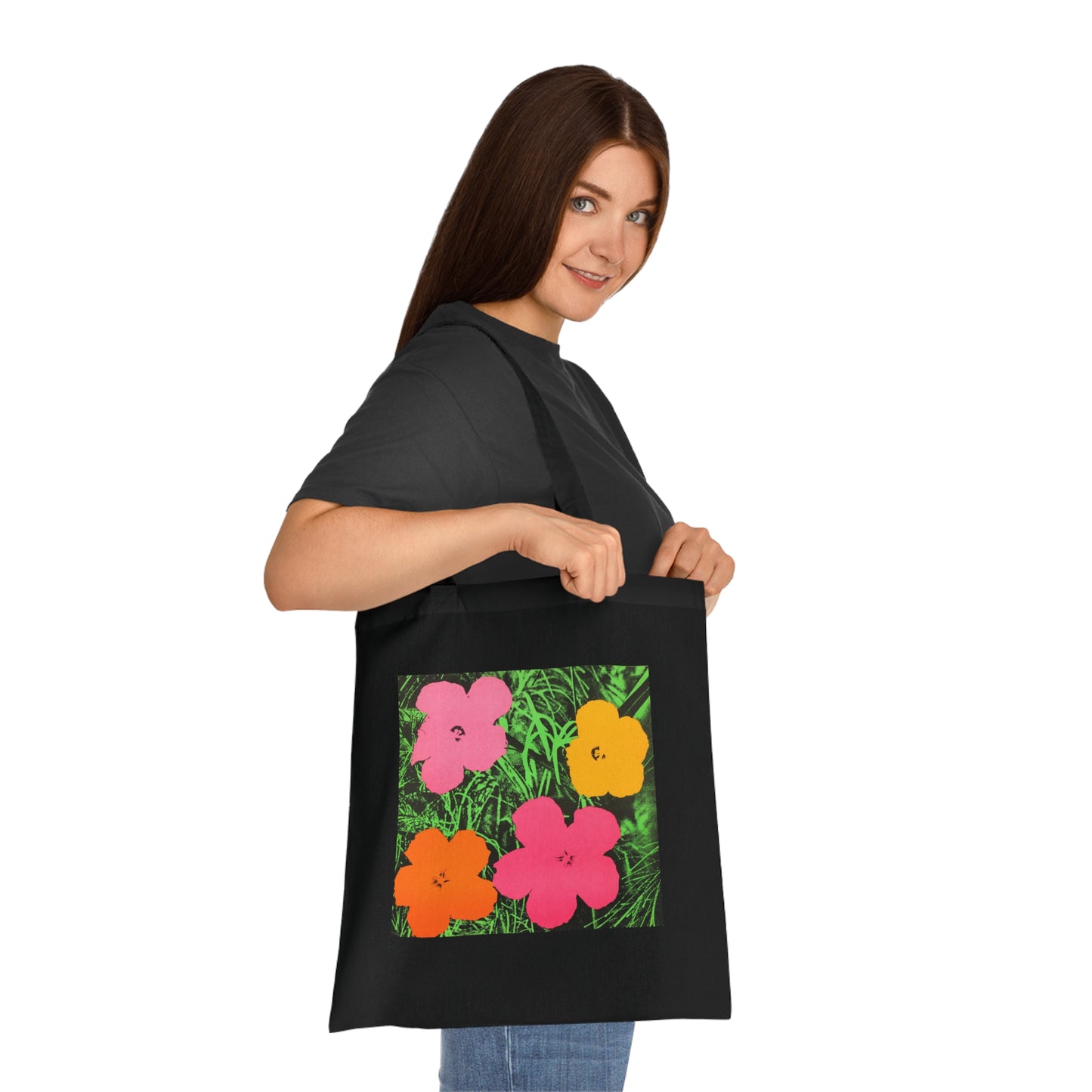 a woman holding a black bag with flowers on it