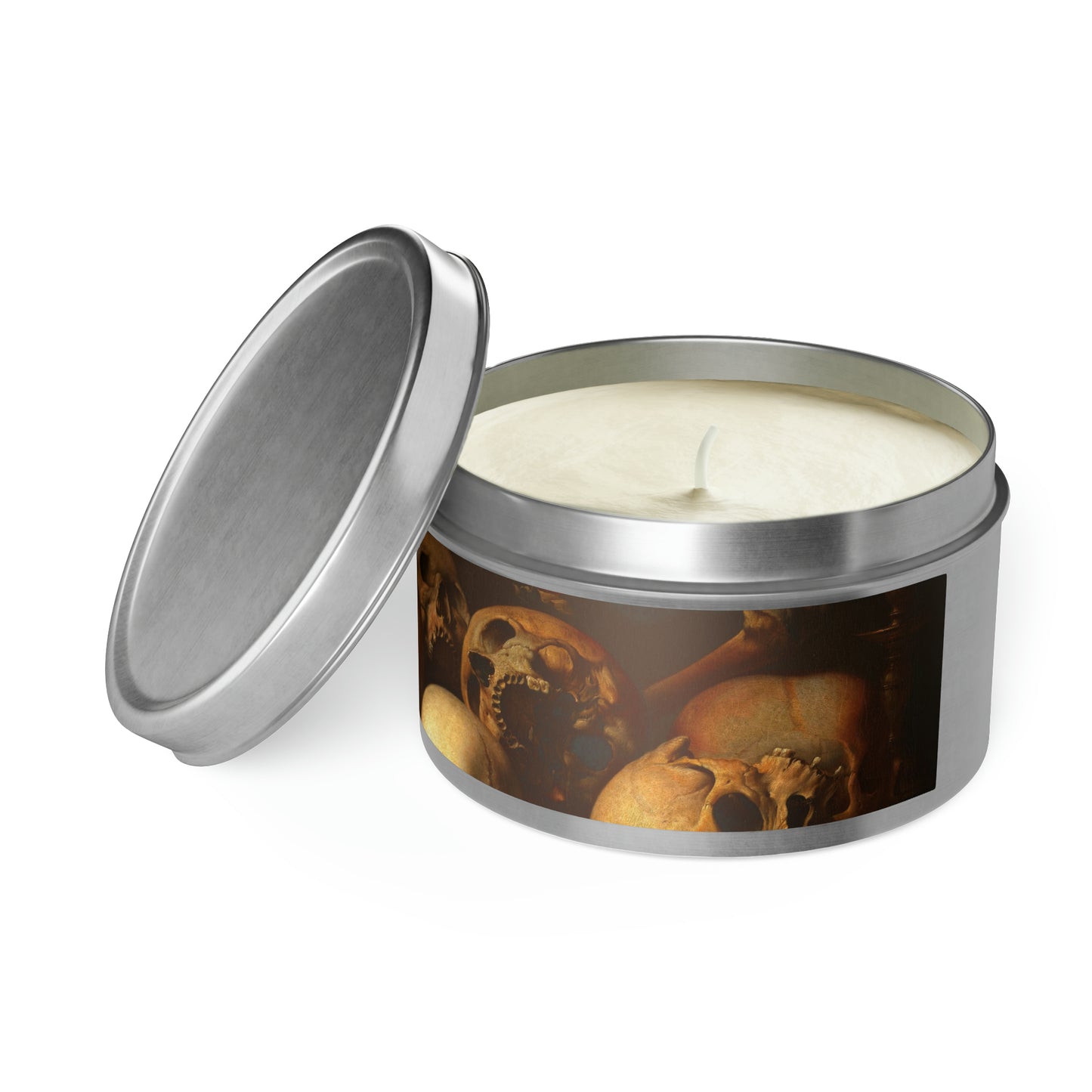 a candle in a tin with a picture of skulls on it