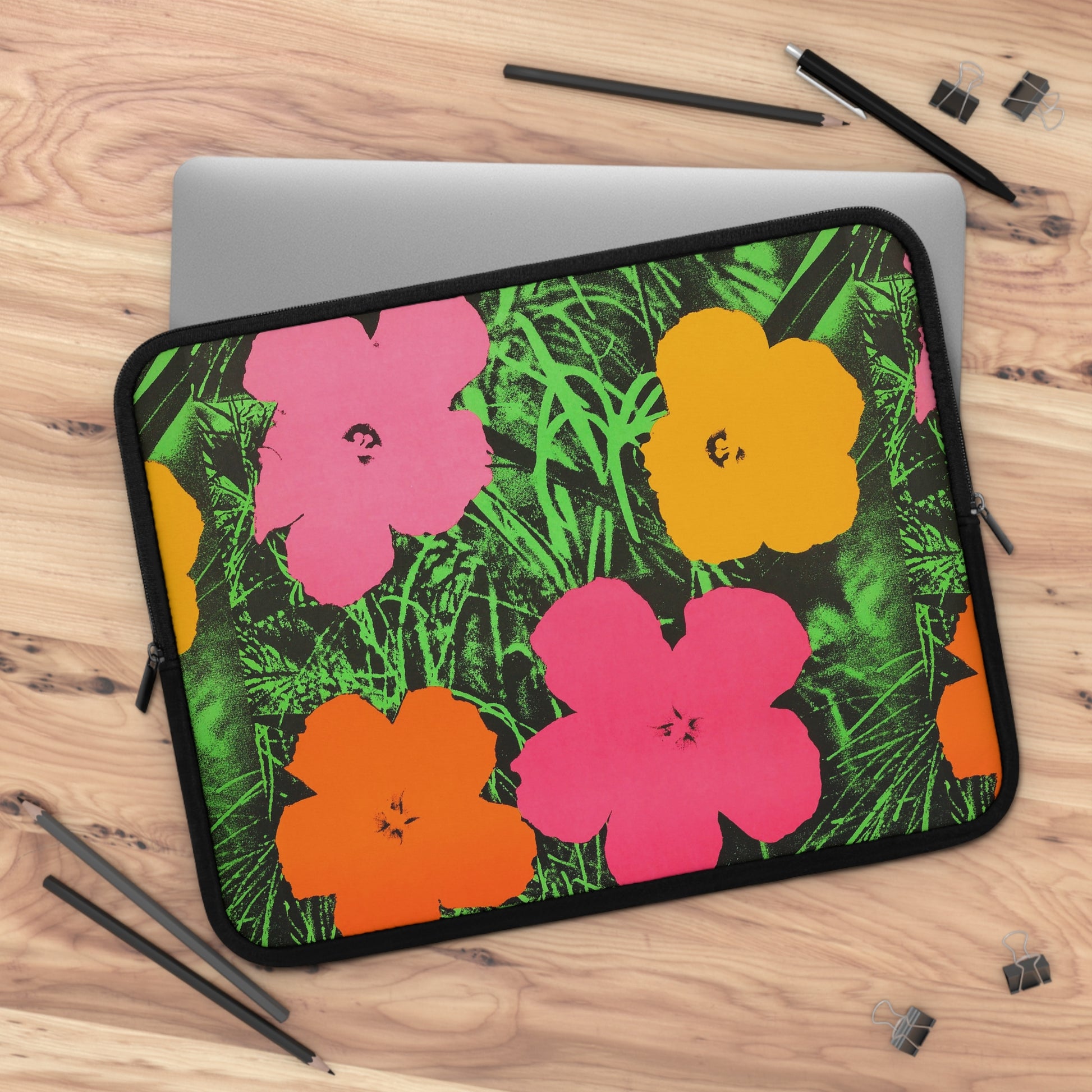 a laptop case with flowers on it on a table