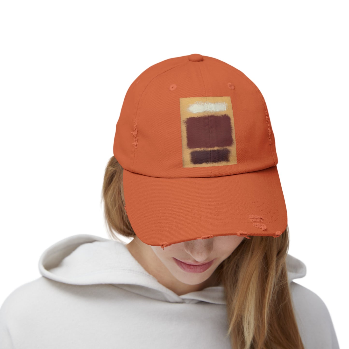 a woman wearing an orange hat with a patch on it