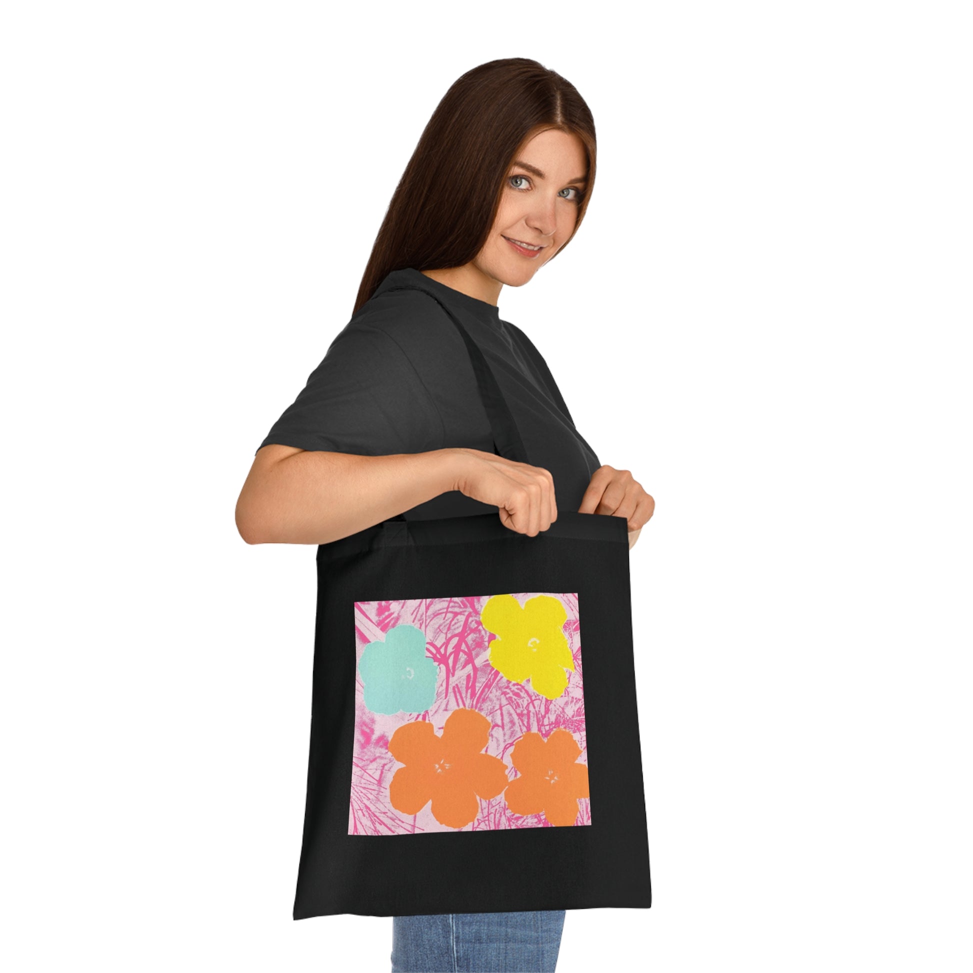 a woman holding a black bag with flowers on it