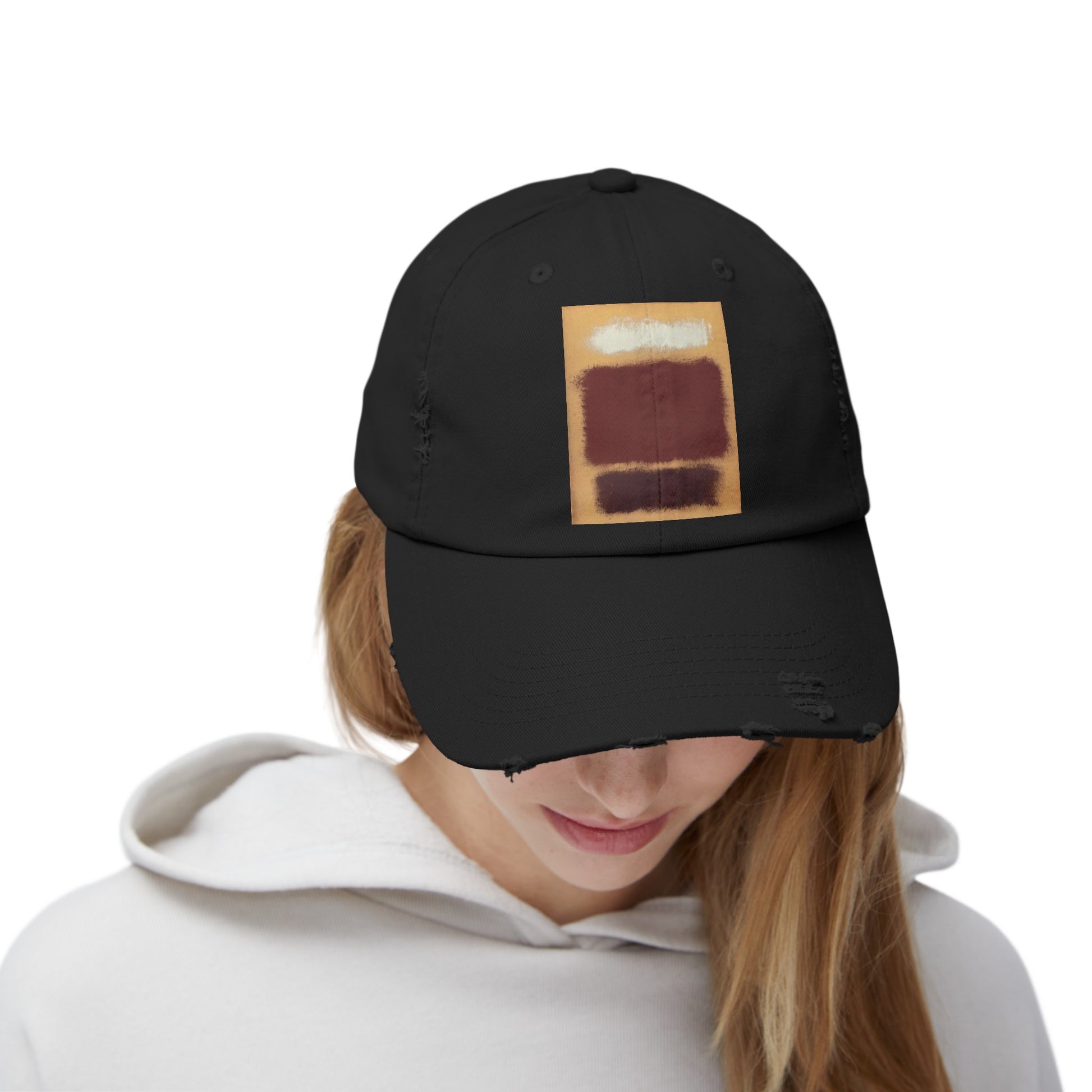 a woman wearing a black hat with a picture of a piece of bread on it