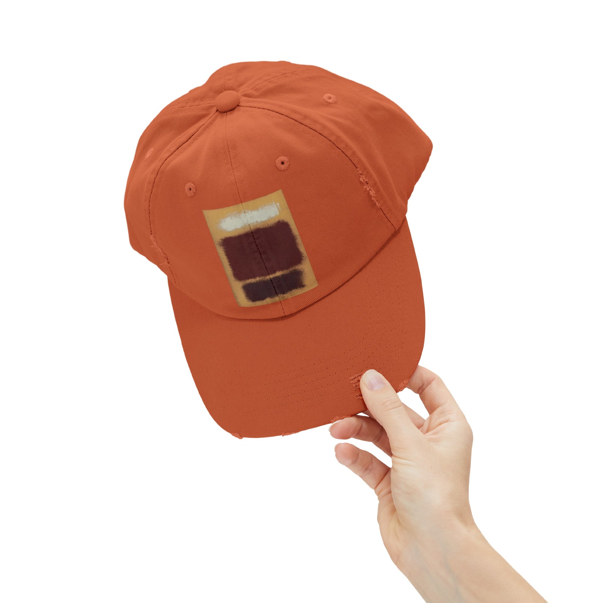 a person holding a baseball cap with a picture of a house on it