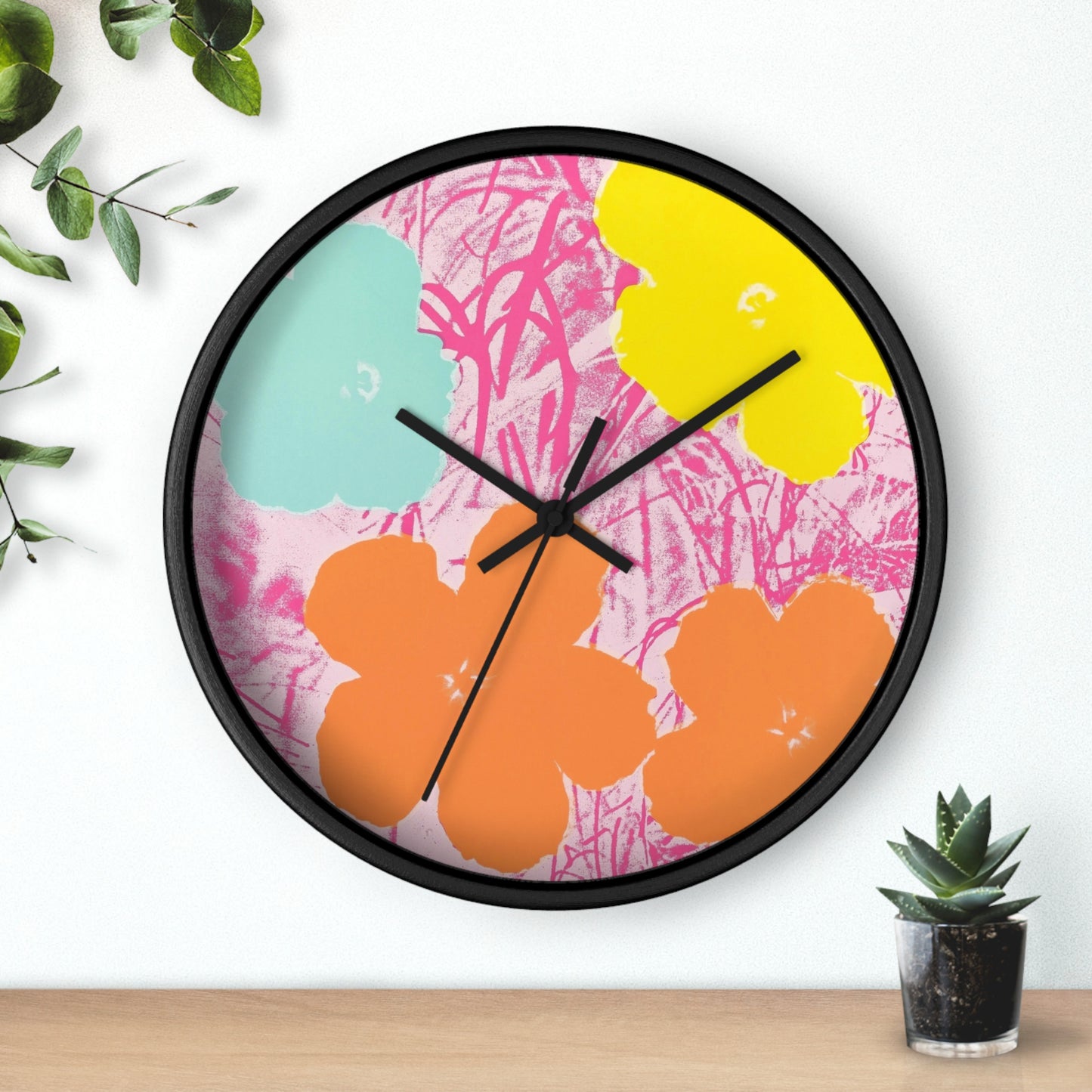 a clock that is on a wall next to a potted plant