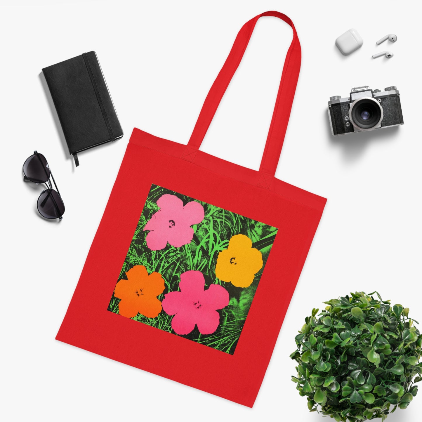 a red tote bag with a picture of flowers on it