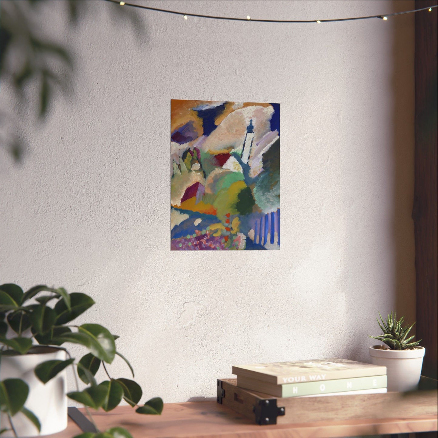 a painting hanging on a wall next to a potted plant