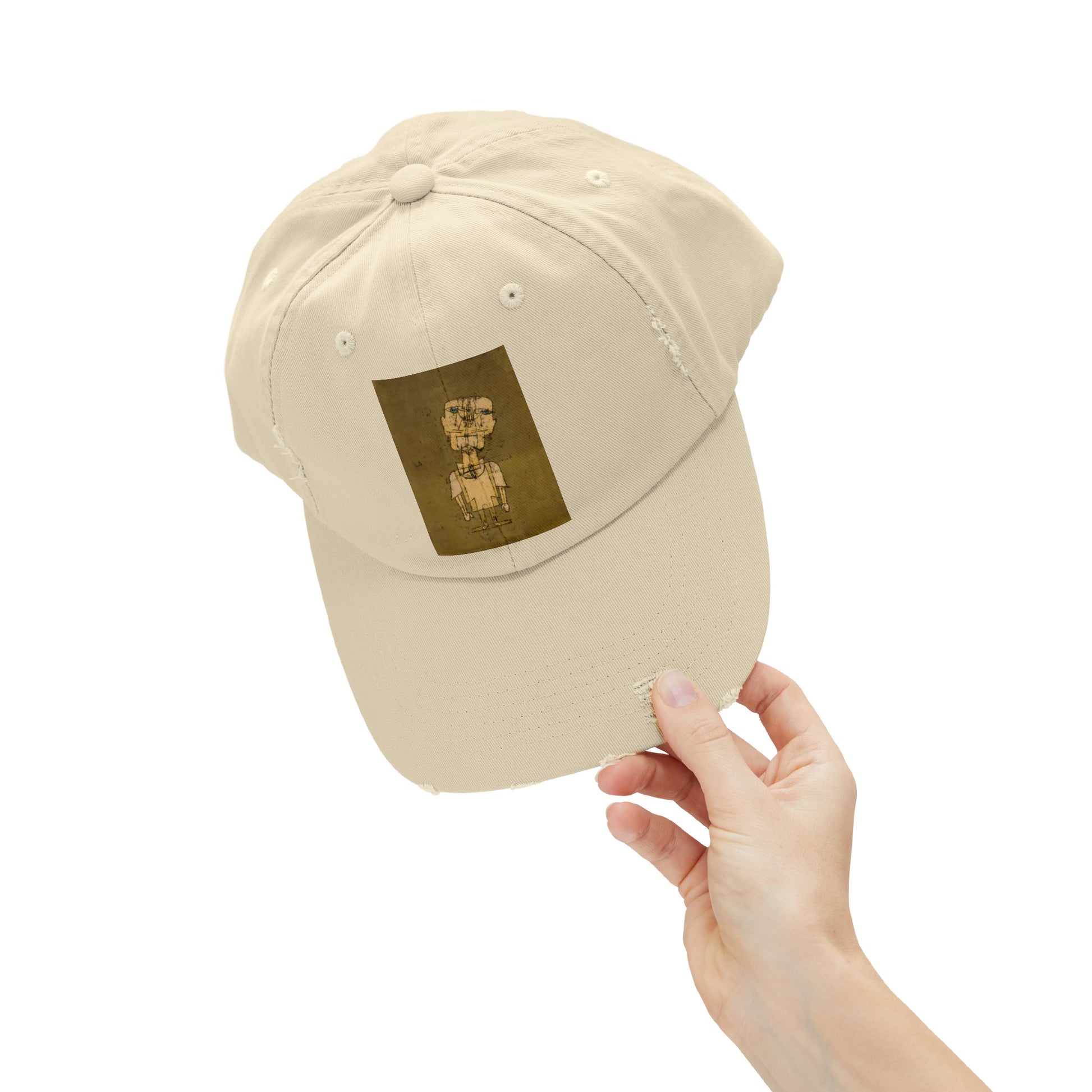 a person holding up a hat with a picture on it