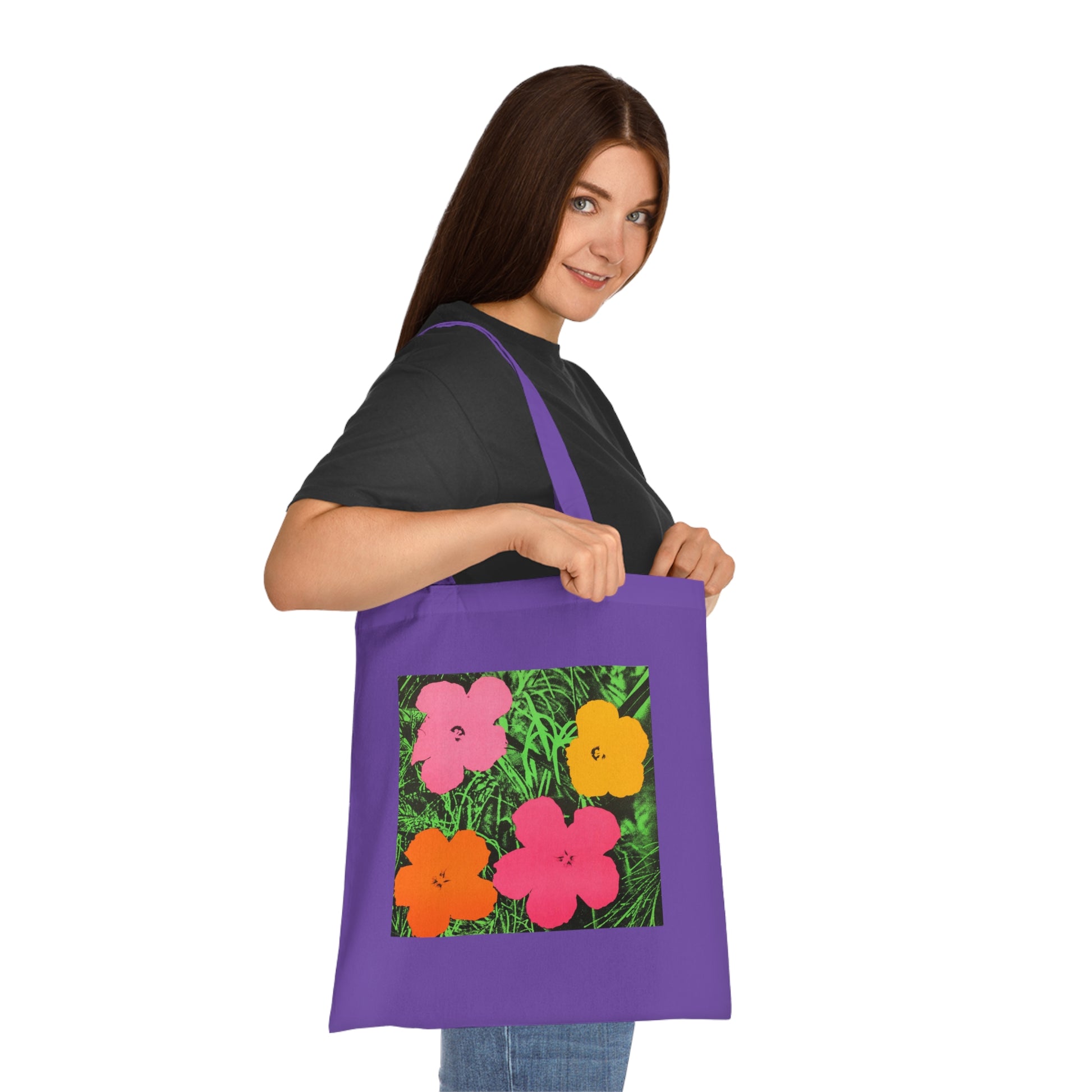 a woman holding a purple bag with flowers on it