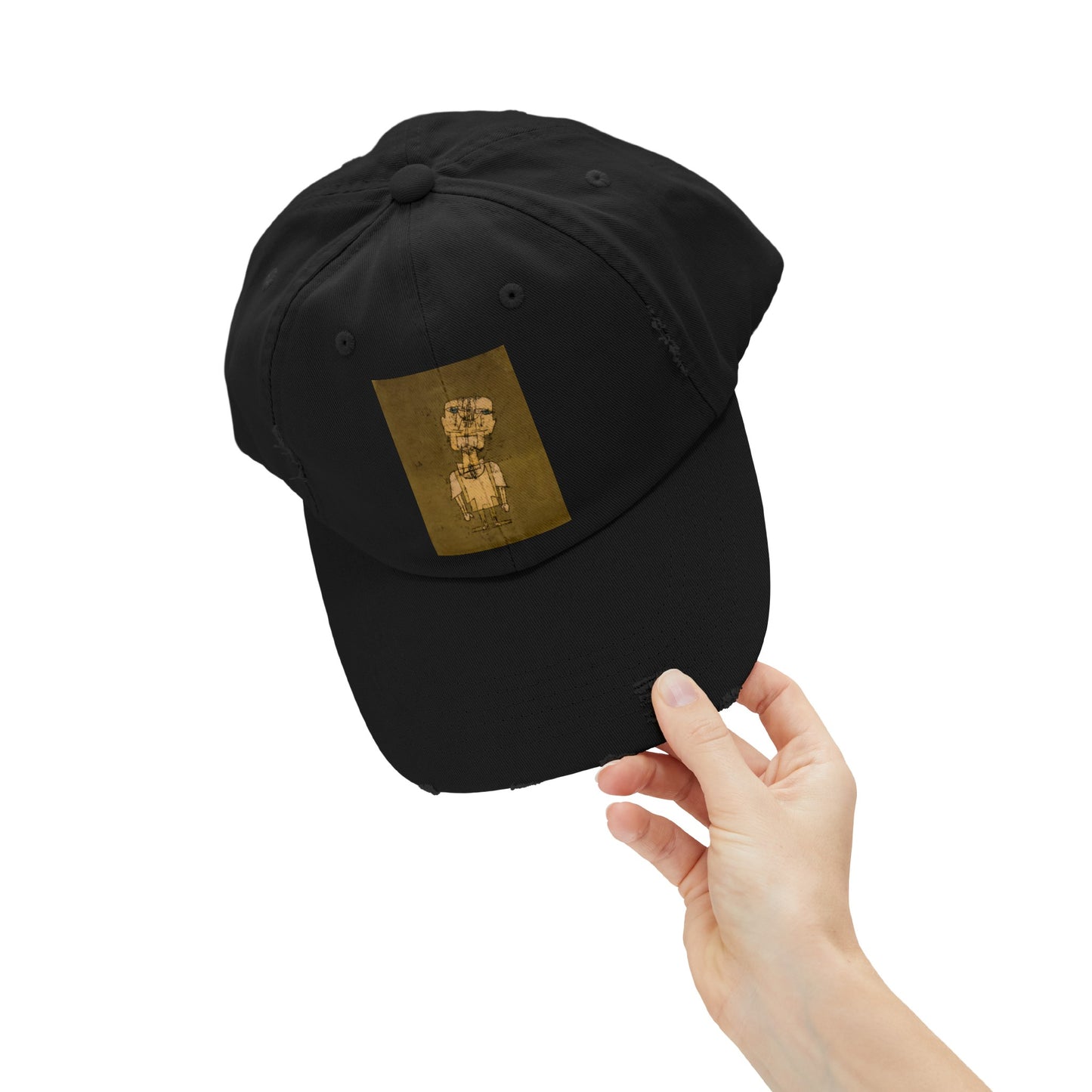 a person holding a black hat with a gold bear on it