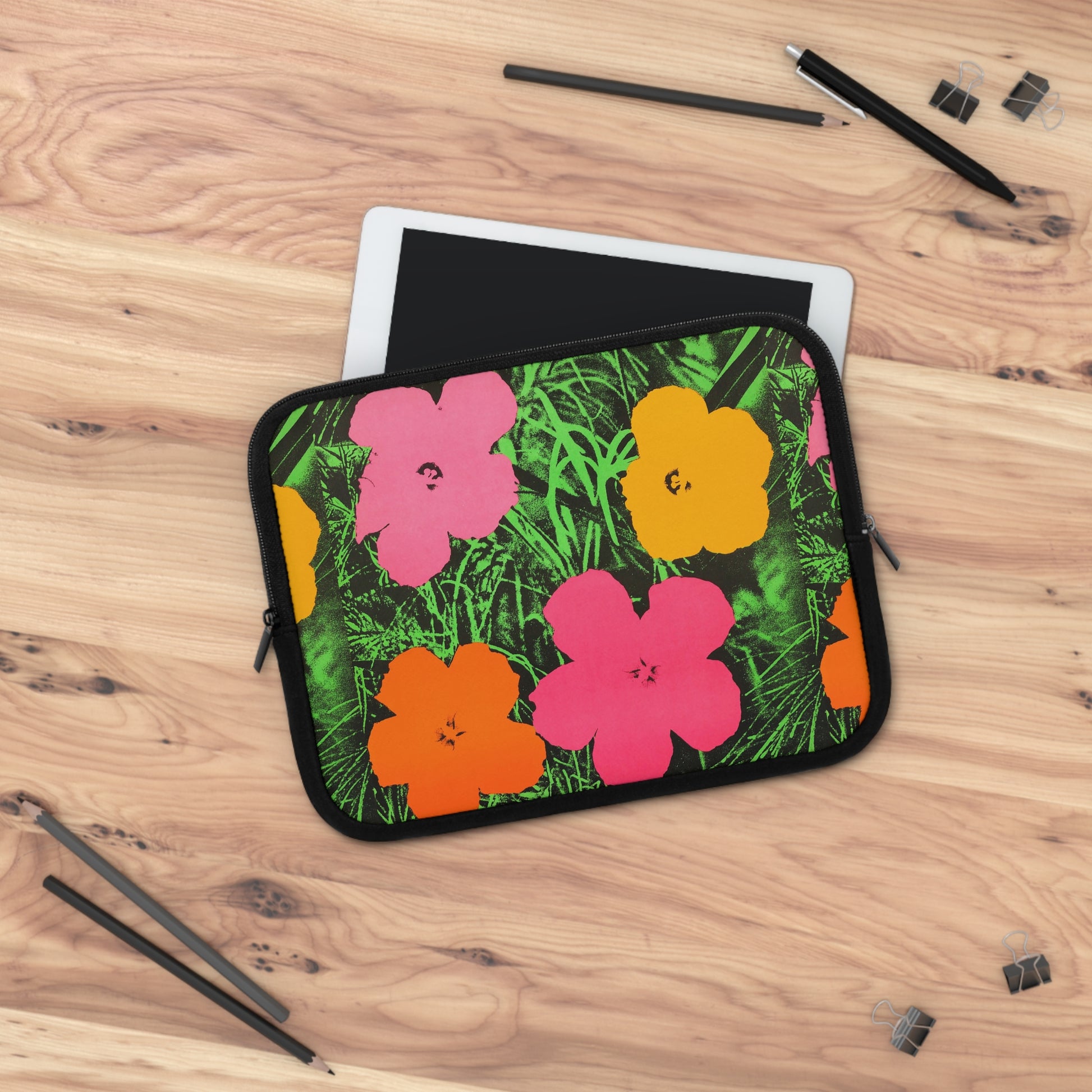 a tablet case with flowers on it sitting on a table